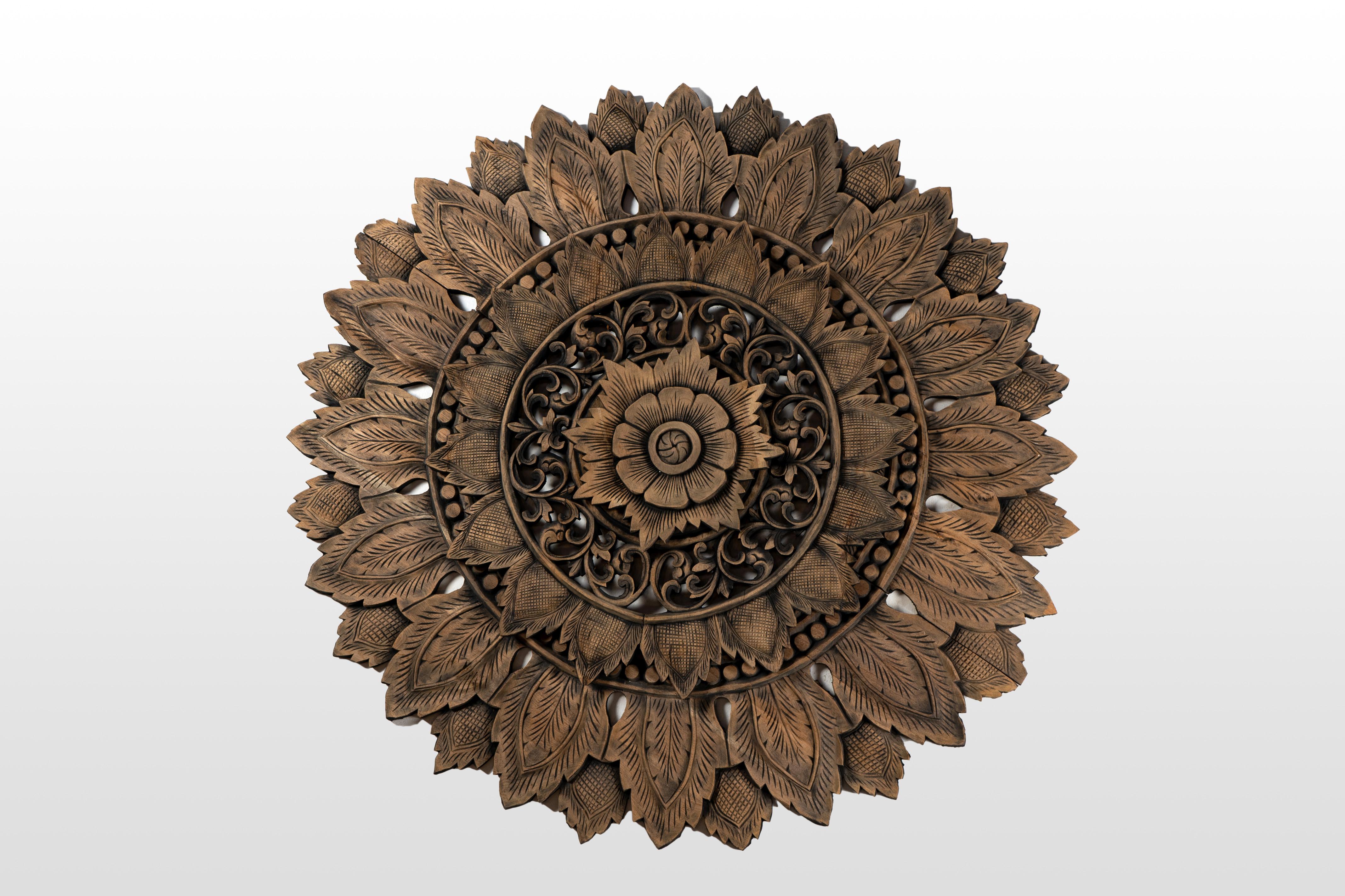 The lotus flower has been a symbol of spiritual purity and enlightenment ever since the time of the Buddha. These wooden lotus flowers are meticulous reproductions of ceiling decorations found in Thai temples.  In  some temples, lotuses are painted