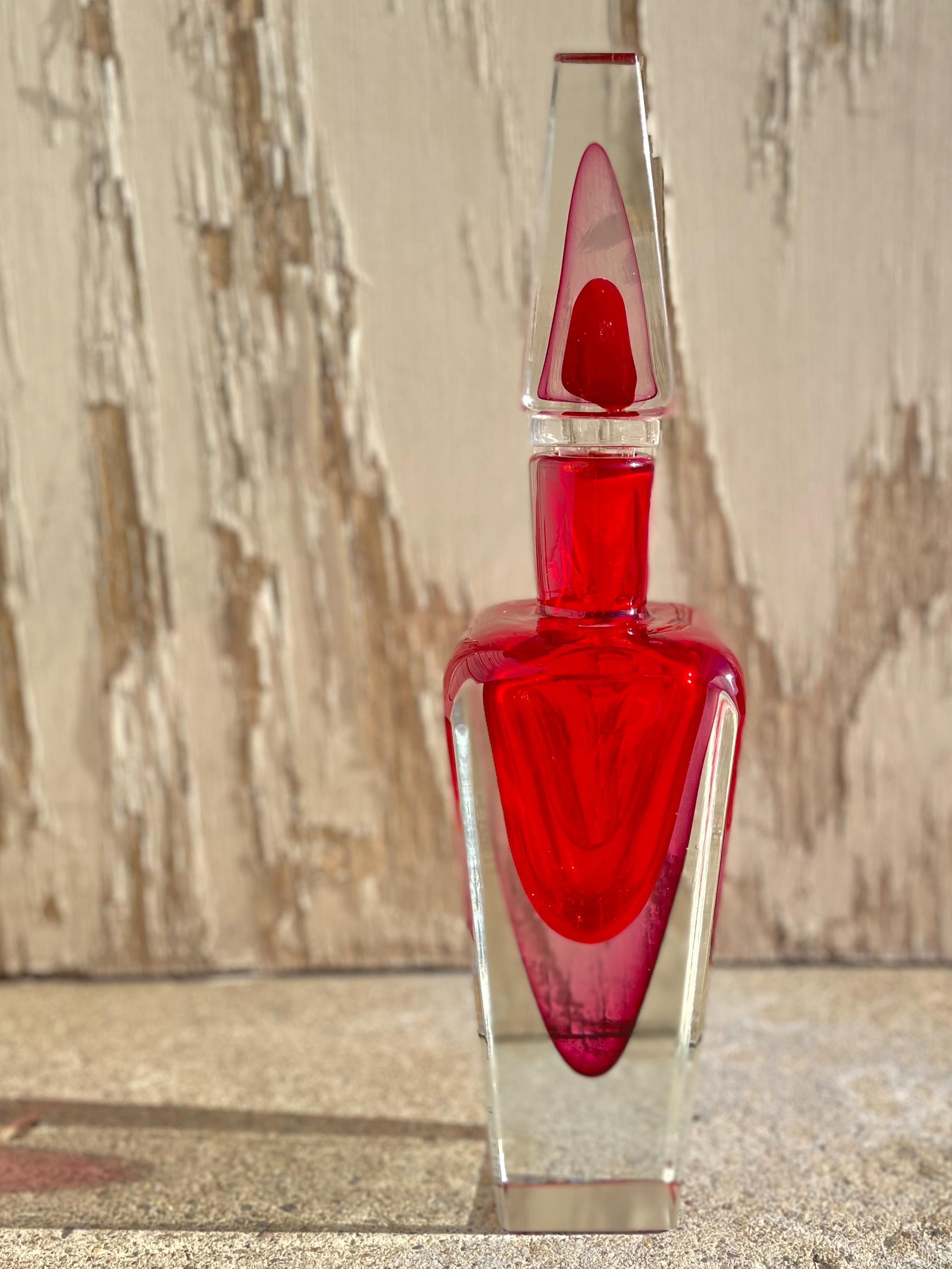 An Italian Murano Mid-Century Modern Sommerso bottle by, Seguso Vetri d'Arte blown in the Sommerso technique with pink, red coloration cased in clear blown glass bottle with matching stopper and then further polished. The vase is unmarked and is