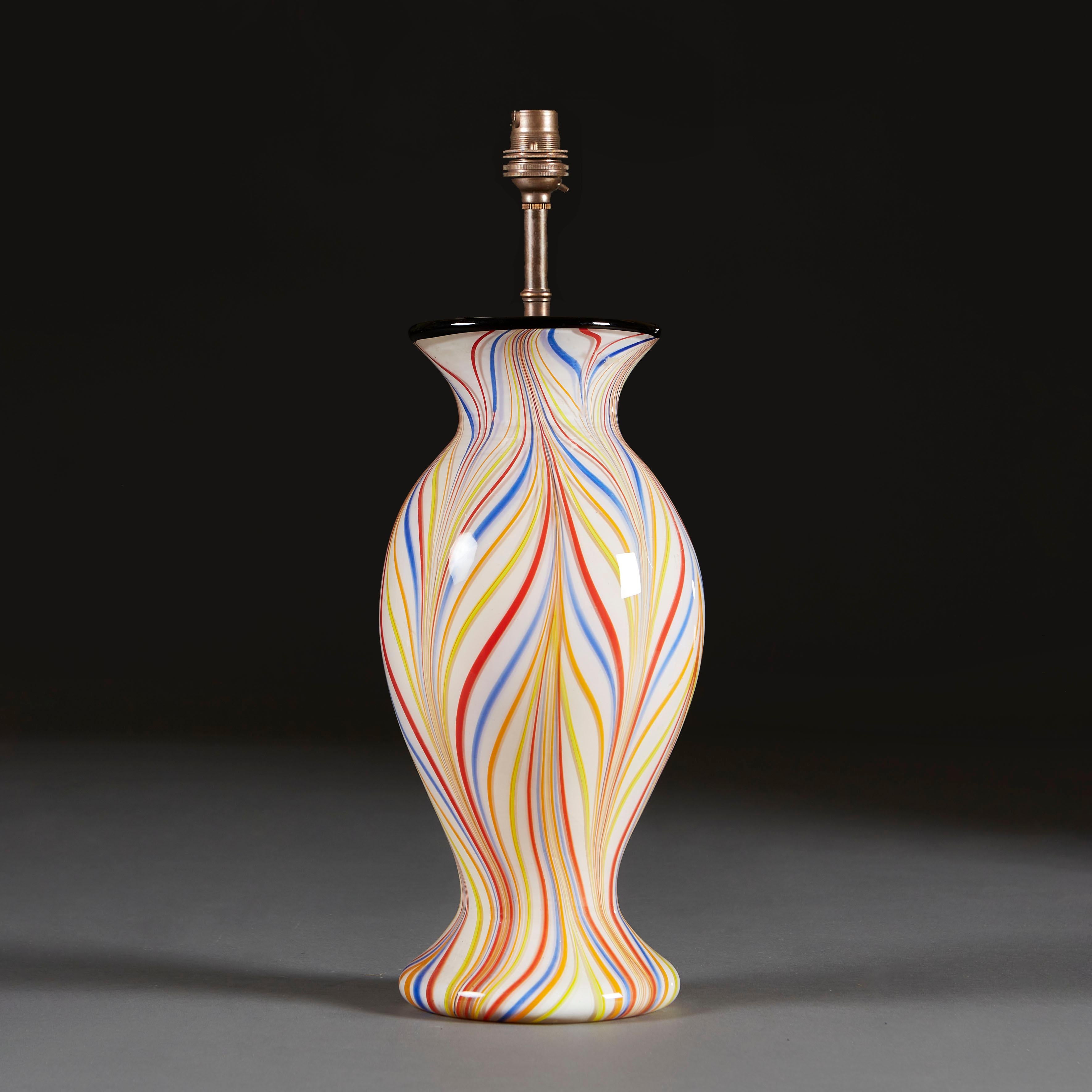 An unusual mid 20th century Murano vase, decorated with spirals of alternating colour, supported on a circular foot.

Currently wired for the UK with bronze colour wire with torpedo switch, with bayonet cap bulb fitting. Please enquire for