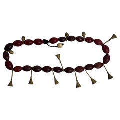 A Naga necklace made of red glass paste beads and bronze trumpets