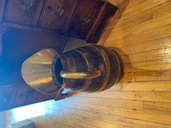 A Napolean shaped wood pitcher with brass bound bands