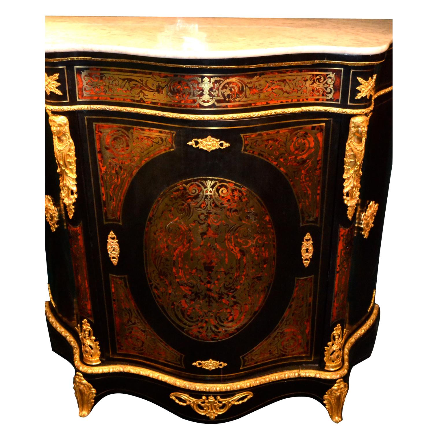 A period French Napoleon III serpentine form cabinet in ebonized wood with Boulle marquetry in brass and tortoiseshell, bronze ornaments, and conforming white marble top.  The mahogany interior has two shelves.




   
