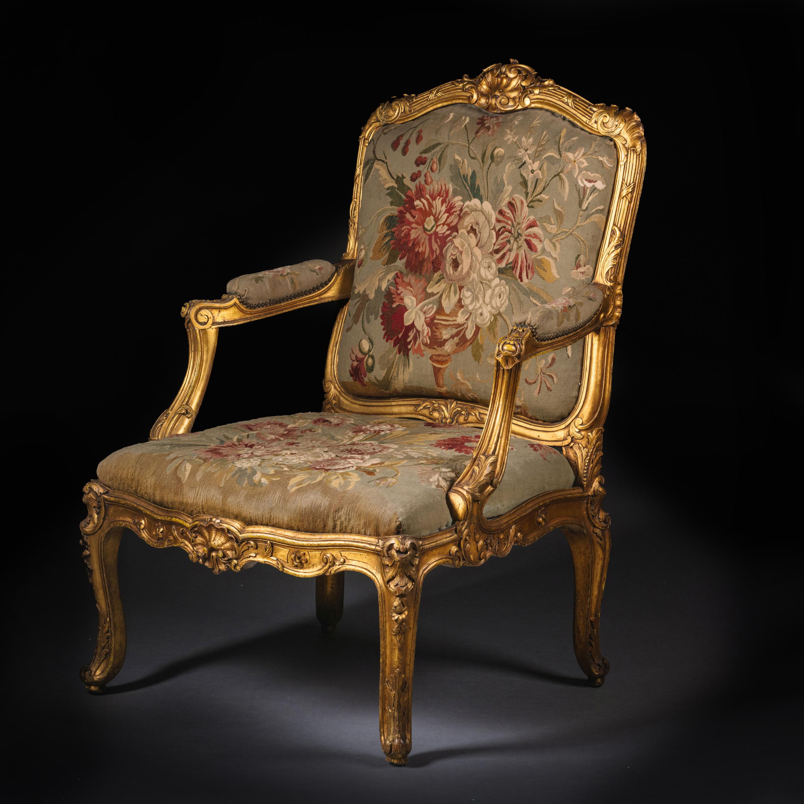 Fauteuil Napoléon III en bois sculpté et doré à la manière de Michele Cruchet.

Ce beau fauteuil est richement sculpté de feuillages, de coquillages et de C.C. Il est garni de tapisserie florale de Beauvais. 

Les proportions généreuses,