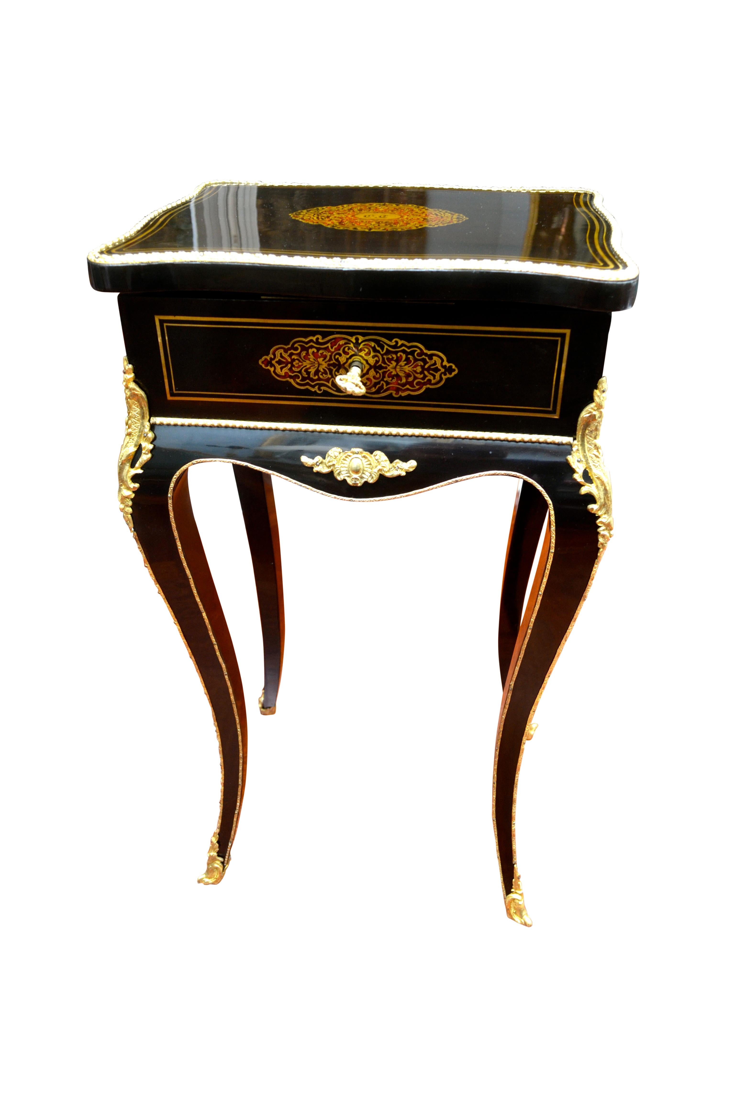 This magnificent jewelry storage and dressing table was produced by the furniture maker Alphonse Tahan (1830-1880), official master cabinetmaker of Napoleon III. The serpentine shaped ebonized top is bordered by ormolu banding around the surface and