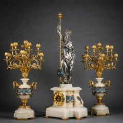 A Napoleon III Gilt and Silvered Bronze, Onyx and Enamel Figural Clock Set