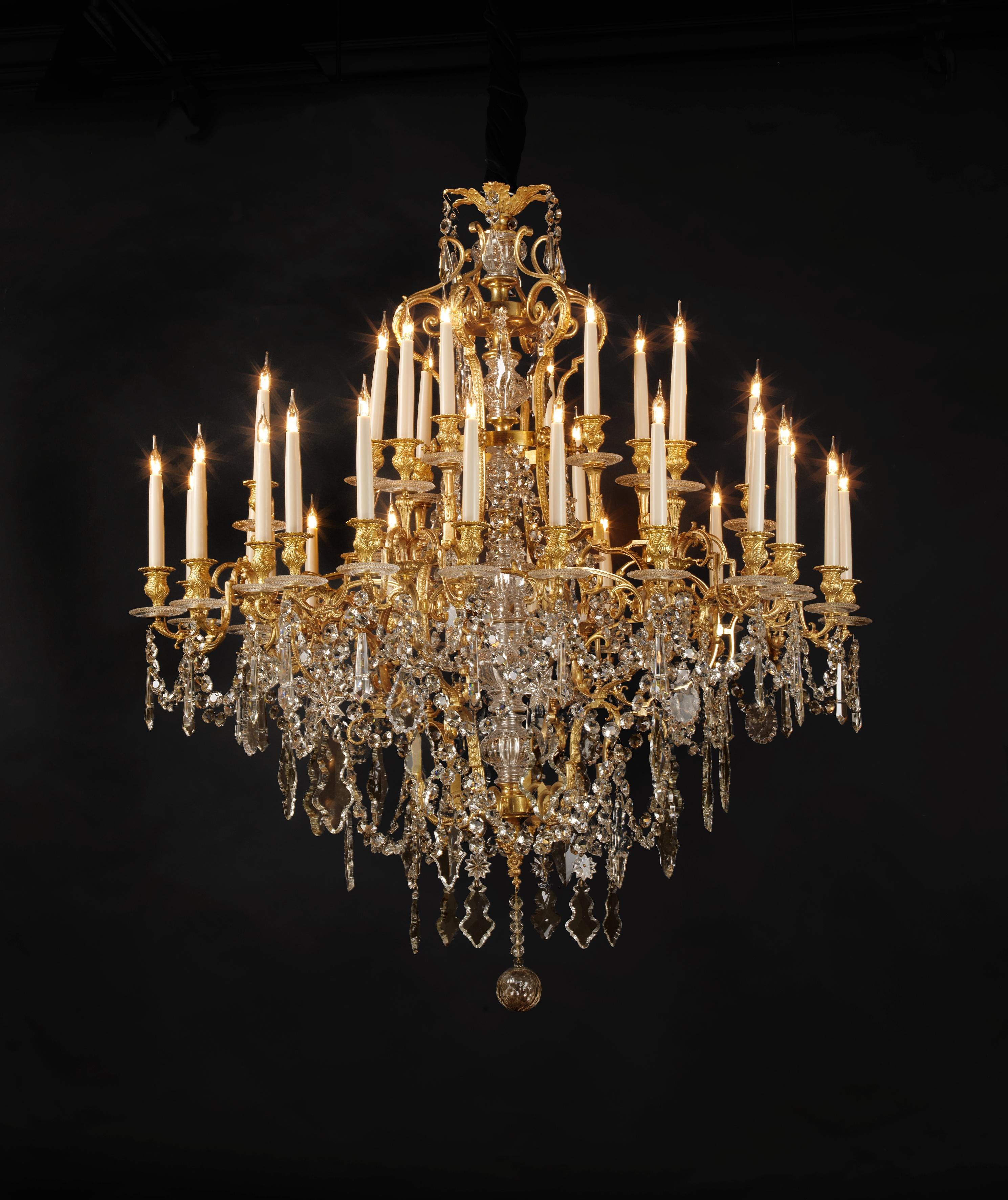 A large and impressive Napoléon III gilt bronze and cut-glass thirty-six light chandelier.

French, circa 1870. 

This fine chandelier has a gilt bronze frame issuing scrolling foliate candle arms terminating in circular glass drip-trays and
