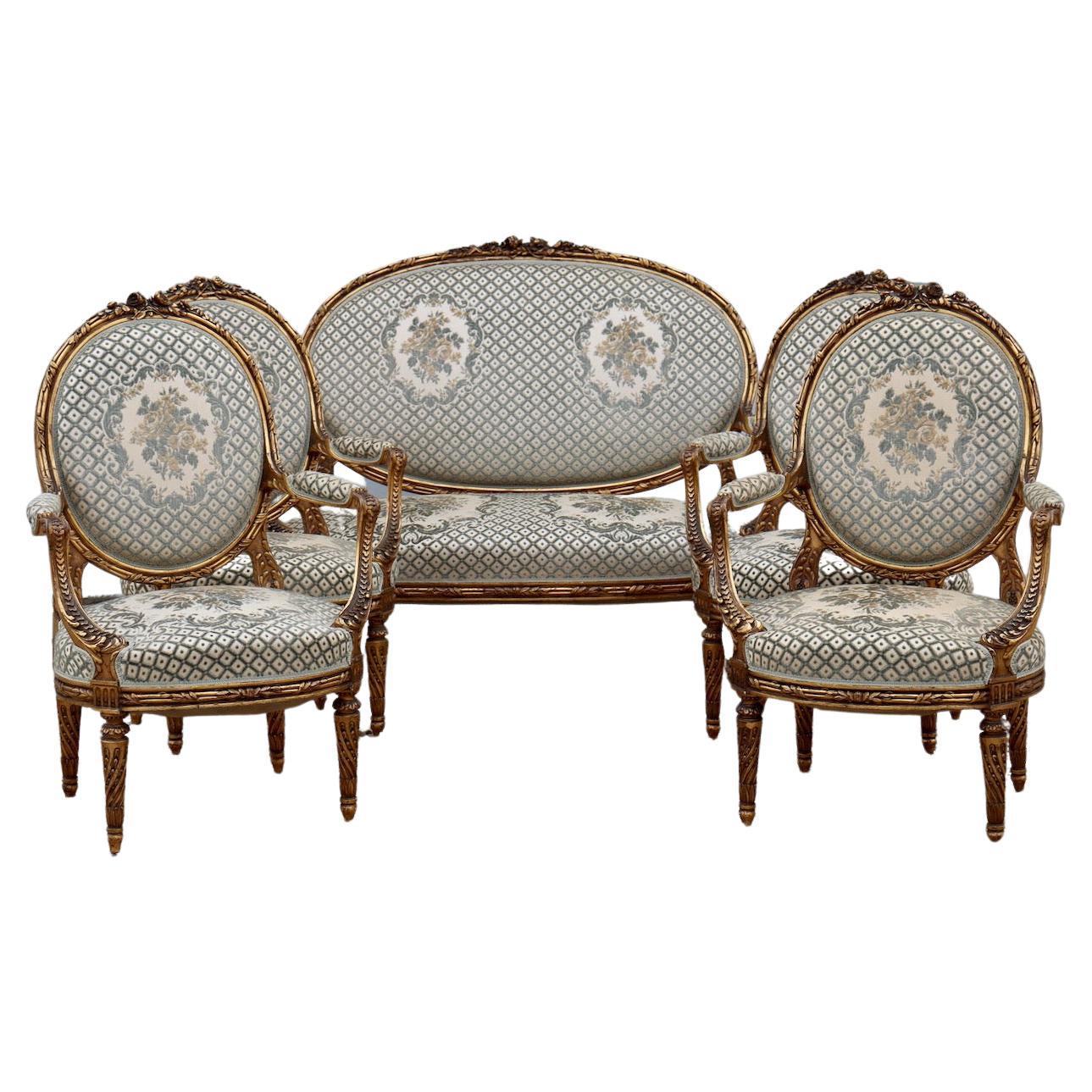 A Napoleon III Louis XVI Style Mobilier de Salon 

In gilded, moulded and very finely carved wood
Comprising a sofa and four large armchairs “à la Reine”, with medallion back topped with a ribbon and flowers, two with different design of flowers,