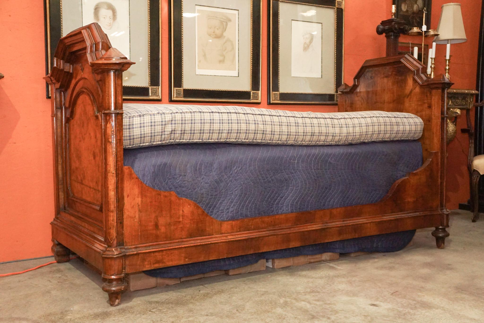 This daybed or sofa was made originally in France circa 1870 in the Napoleon III style and is constructed of walnut and burled walnut veneers used to dramatically show off the wood selection and grain patterns. Large profiles and massive flat or