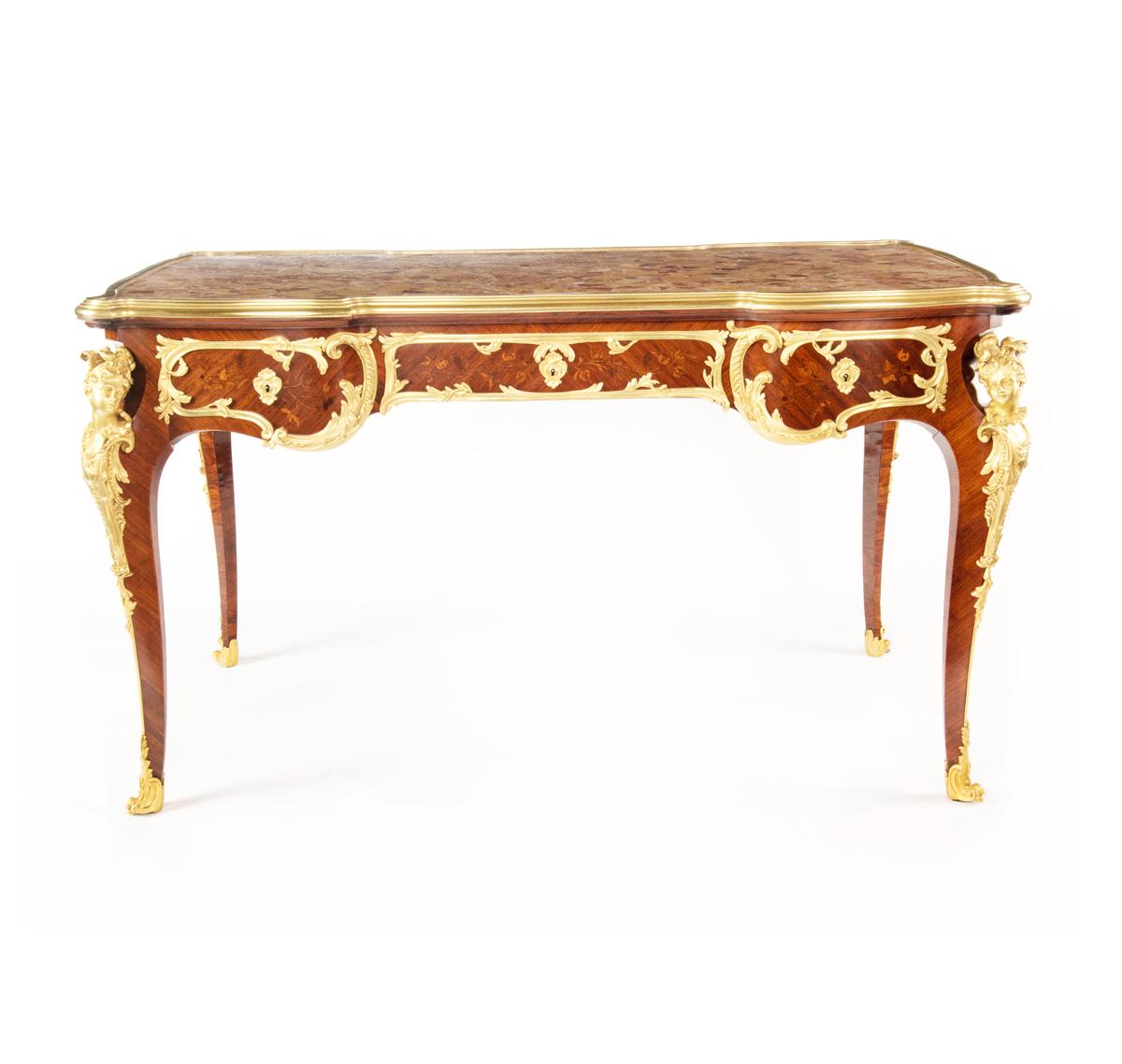 A Napoleon kingwood marble free-standing writing table attributed to Sormani, the shaped rectangular top inset with Breche d’Alep marble within wide ormolu edging, all above three frieze drawers on one side with dummy fronts on the other, all raised