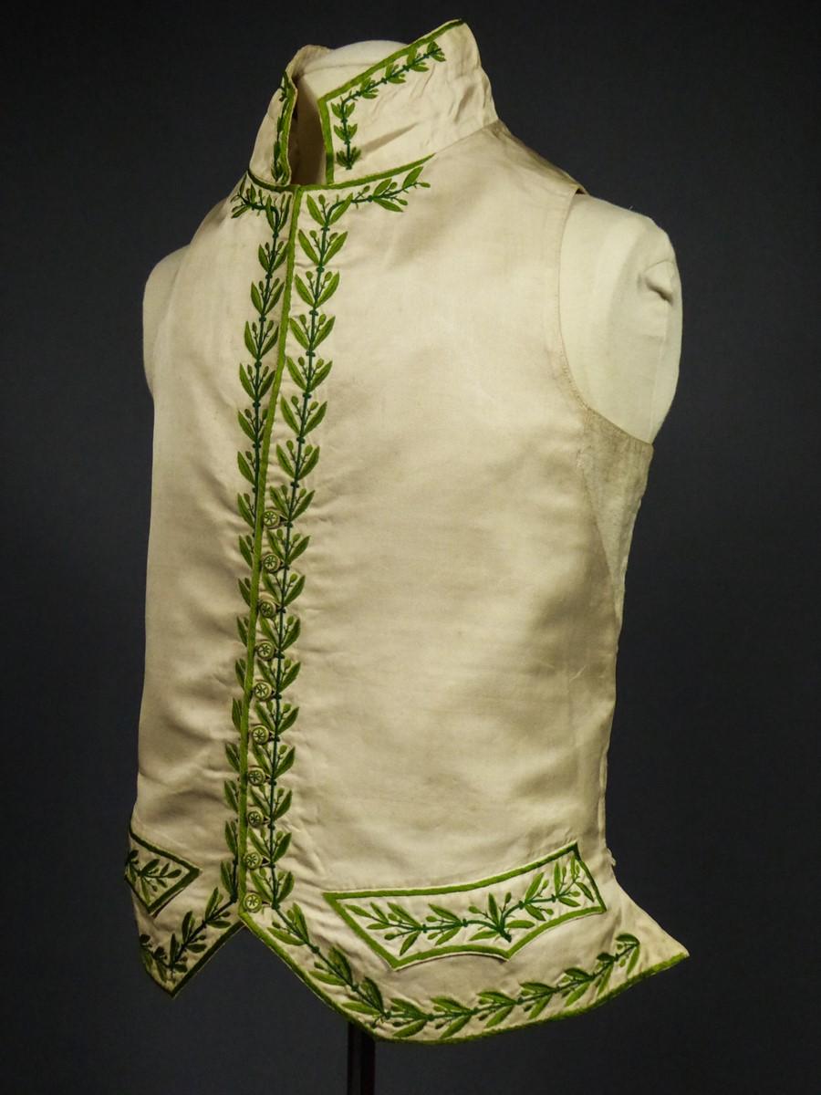 Circa 1810/1820
France

Beautiful First Empire formal man's waistcoat possibly from the French Académie in cream silk embroidered with green bays dating from the First French Empire. Cream silk serge embroidered with a  bay frieze in buds with