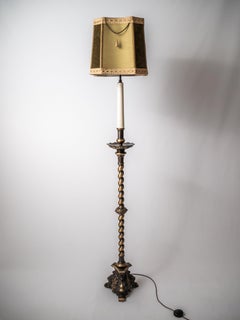 A narrow floor lamp in the baroque style
