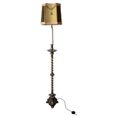 A narrow floor lamp in the baroque style