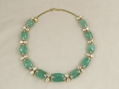 A natural emerald necklace set in 18K yellow gold along with natural diamonds