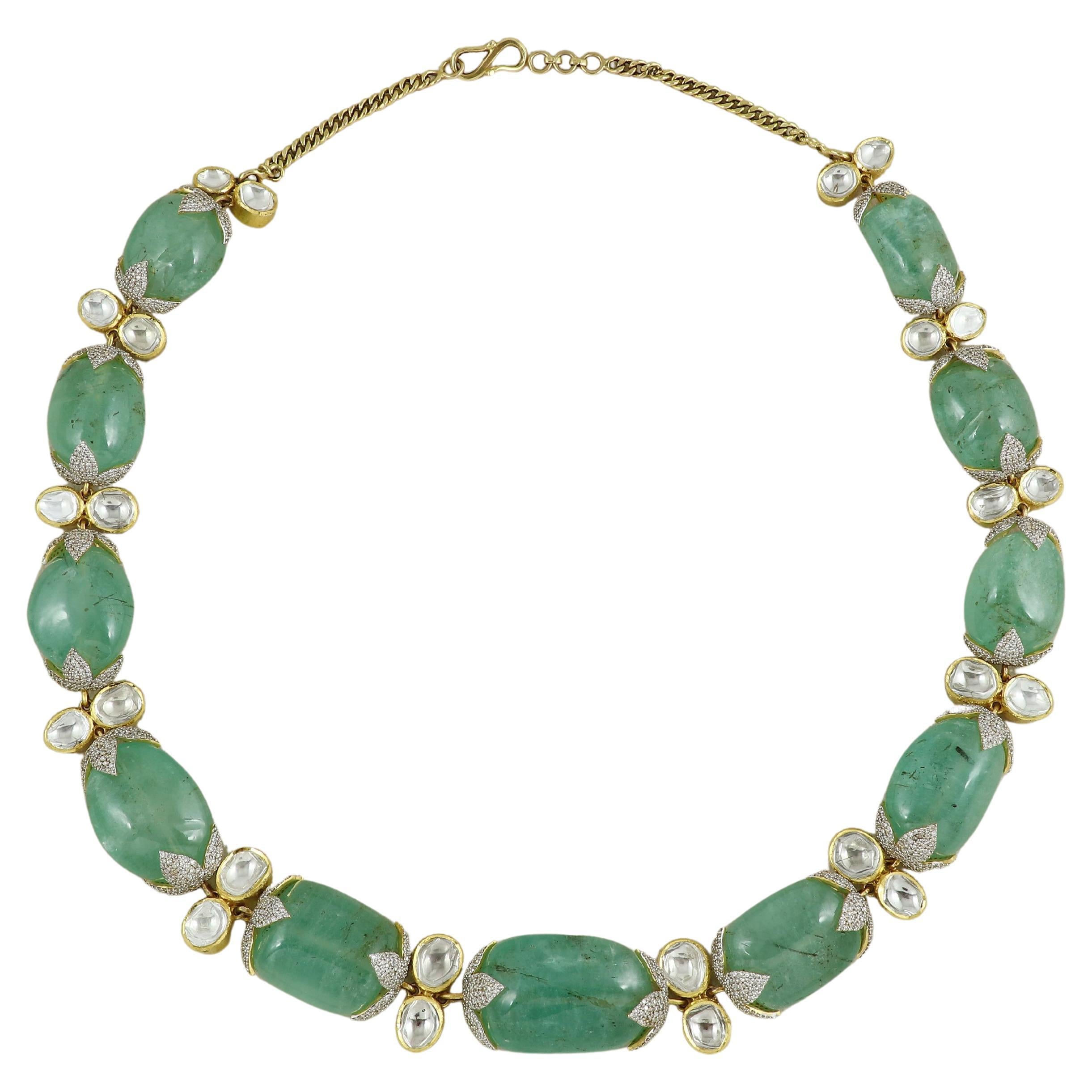 A natural emerald necklace set in 18K yellow gold along with natural diamonds
