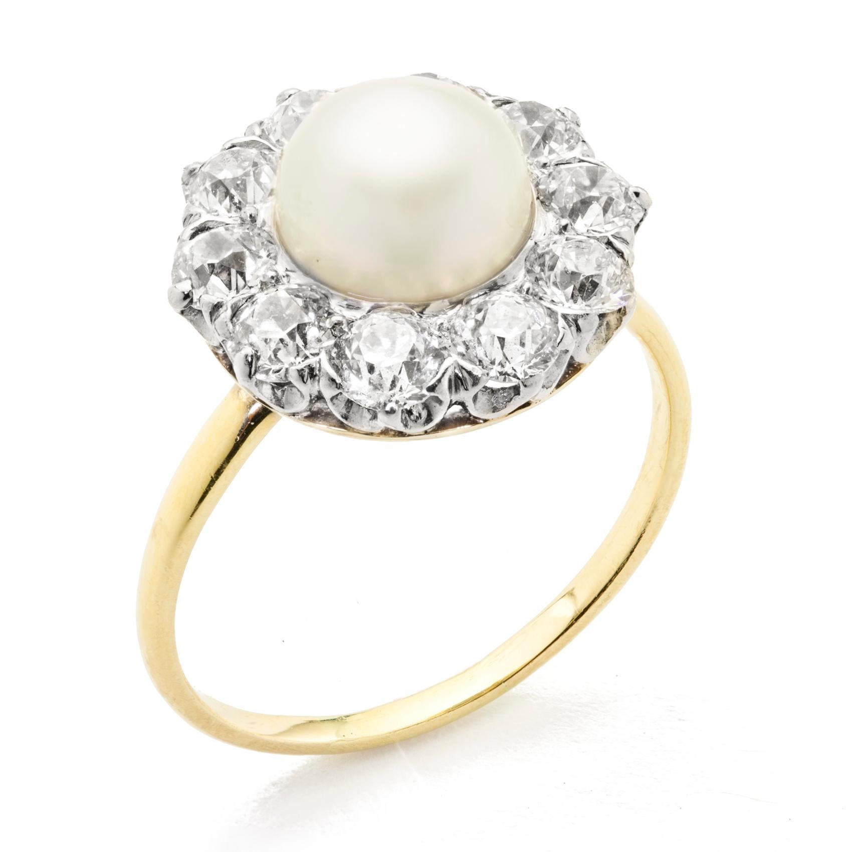 A natural pearl and diamond circular cluster ring, the pearl accompanied by an AnchorCert report  stating the pearl to weigh 2.85 carat, set to the centre of a cluster surround of ten old brilliant-cut diamonds, estimated to weigh a total of 1.80