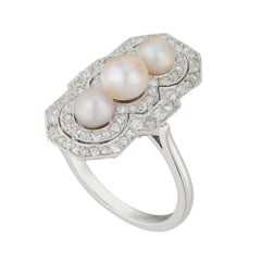 A natural pearl and diamond cluster ring