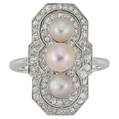 A natural pearl and diamond cluster ring
