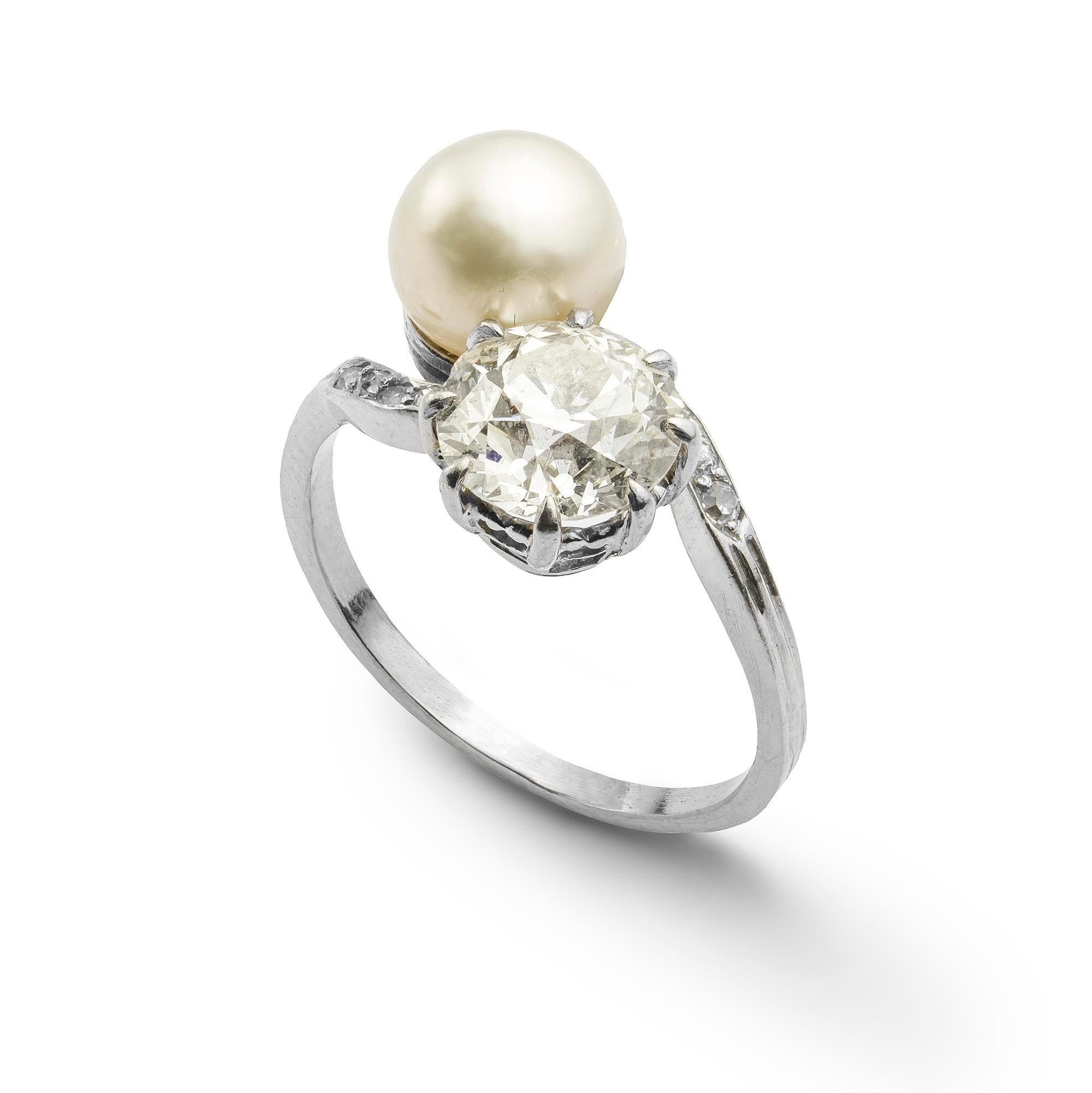 A natural pearl and diamond cross-over ring, the pearl accompanied by GCS Report stating to natural of saltwater origin, set in cross over style with an old brilliant-cut diamond weighing 1.69 carats, accompanied by GCS Report stating to be of J