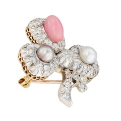A natural pearl, queen conch pearl and diamond clover brooch