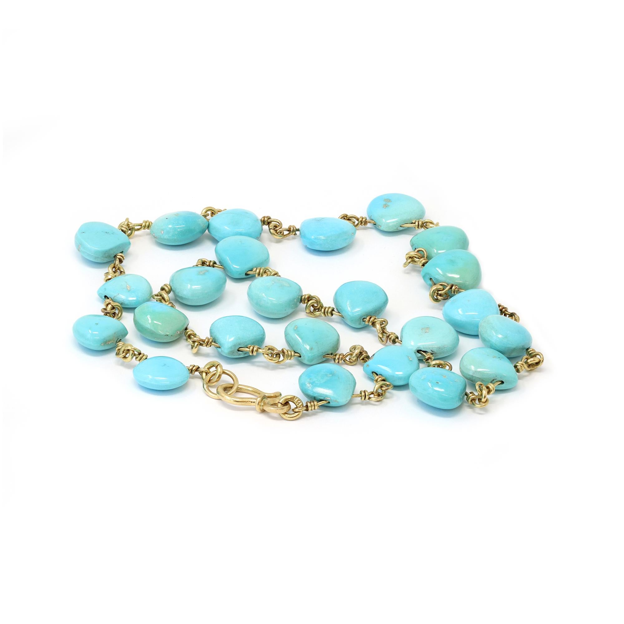 A handmade wired necklace featuring natural untreated turquoise beads. The turquoise beads are calibrated drop shape, very well matched in color. The necklace is made in 18 karat yellow gold. It has a gross weight of 53 grams and measures 17” long.

