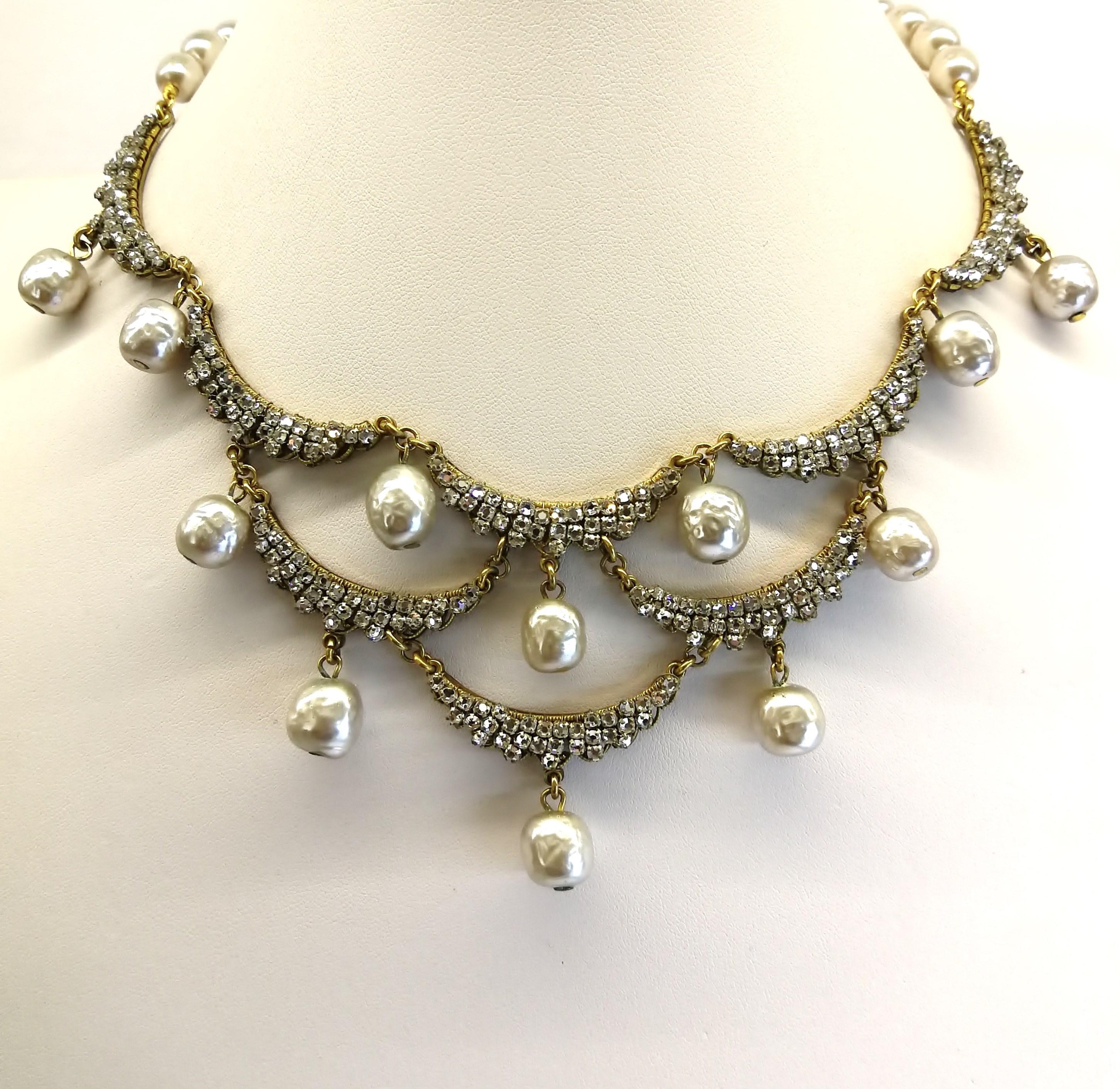 A beautiful and very elegant 'bib' style necklace, with matching earrings, from the 1960s , designed by Robert Clark for Miriam Haskell. Gentle half moon/crescent tiers of rose montes, highlighted with single drop baroque pearls, graduate down to a