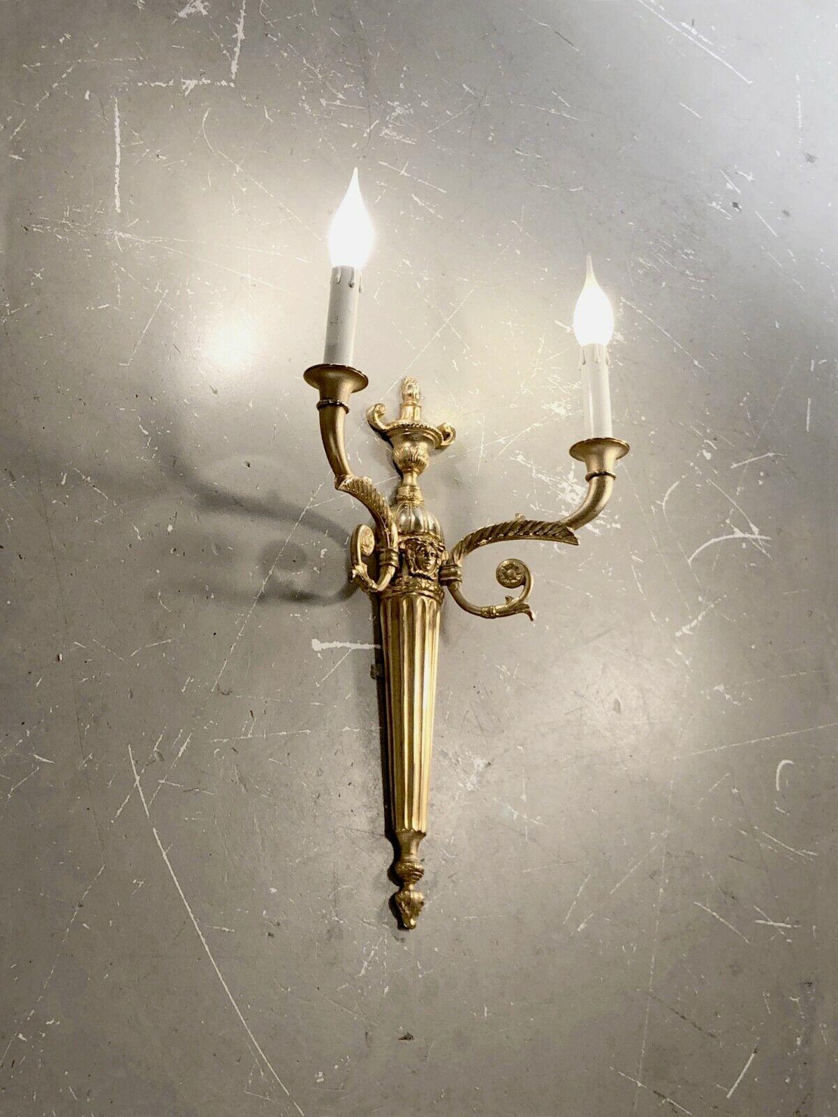 A large wall light with 2 arms of light, Neo-Classical, Baroque, Empire, in gilded bronze with very refined chiseled decorations, by Gianni Versace, Italy 1990.

This wall light features the Versace logo at the top.