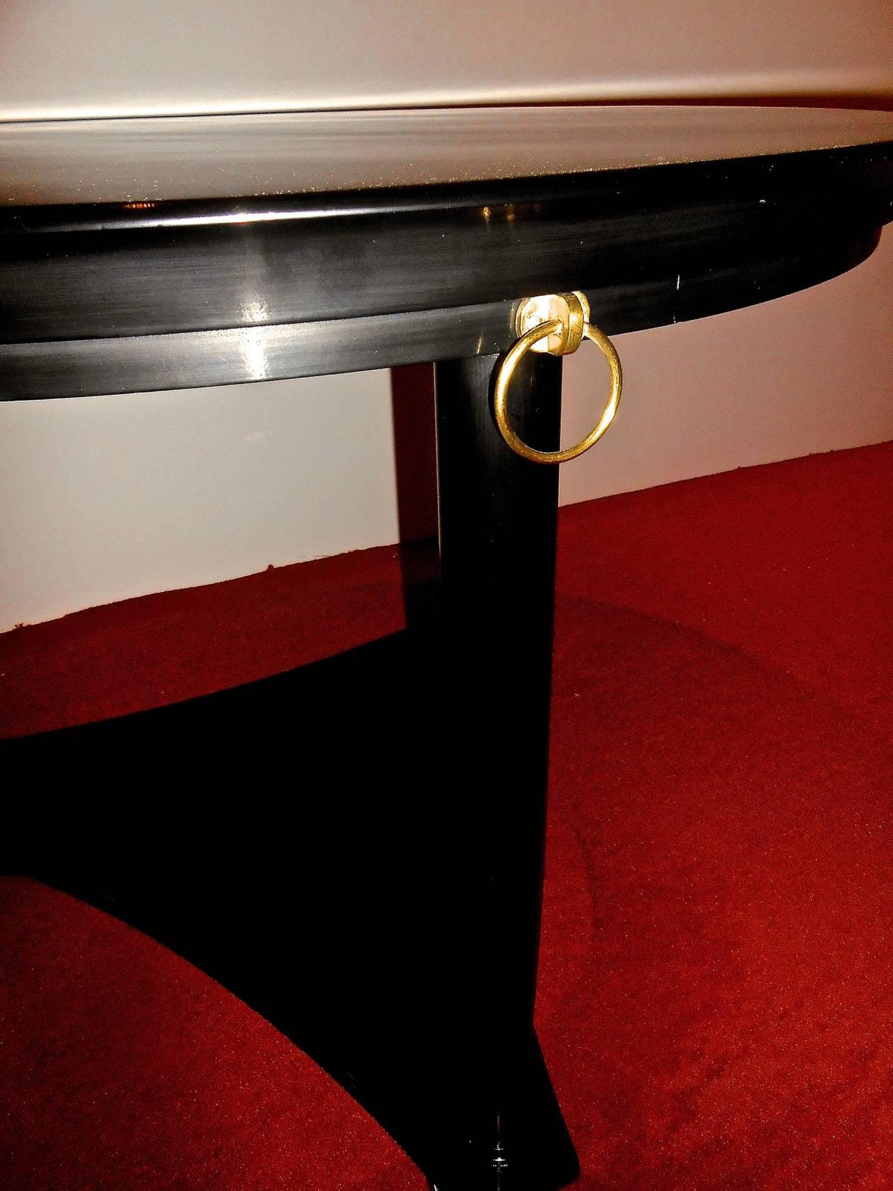 By De Coene-Frères Belgium. Black lacquer, columns feet ending with 3-decorative brass rings. In the spirit of André Arbus,
circa 1950.
 