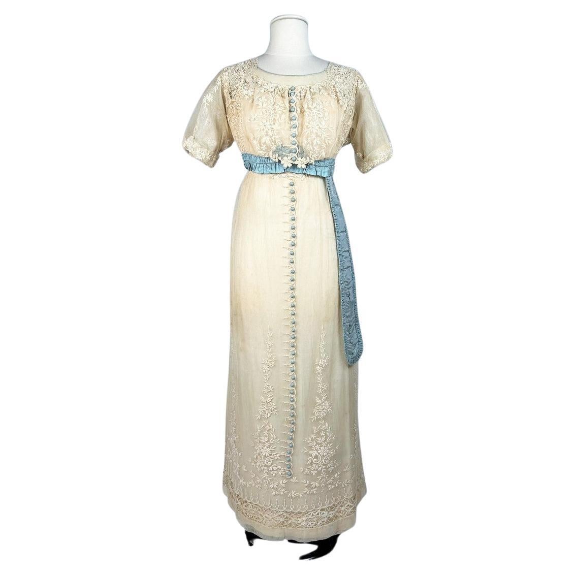 A neo-classical dress in embroidered cotton tulle and taffeta -France Circa 1910 For Sale