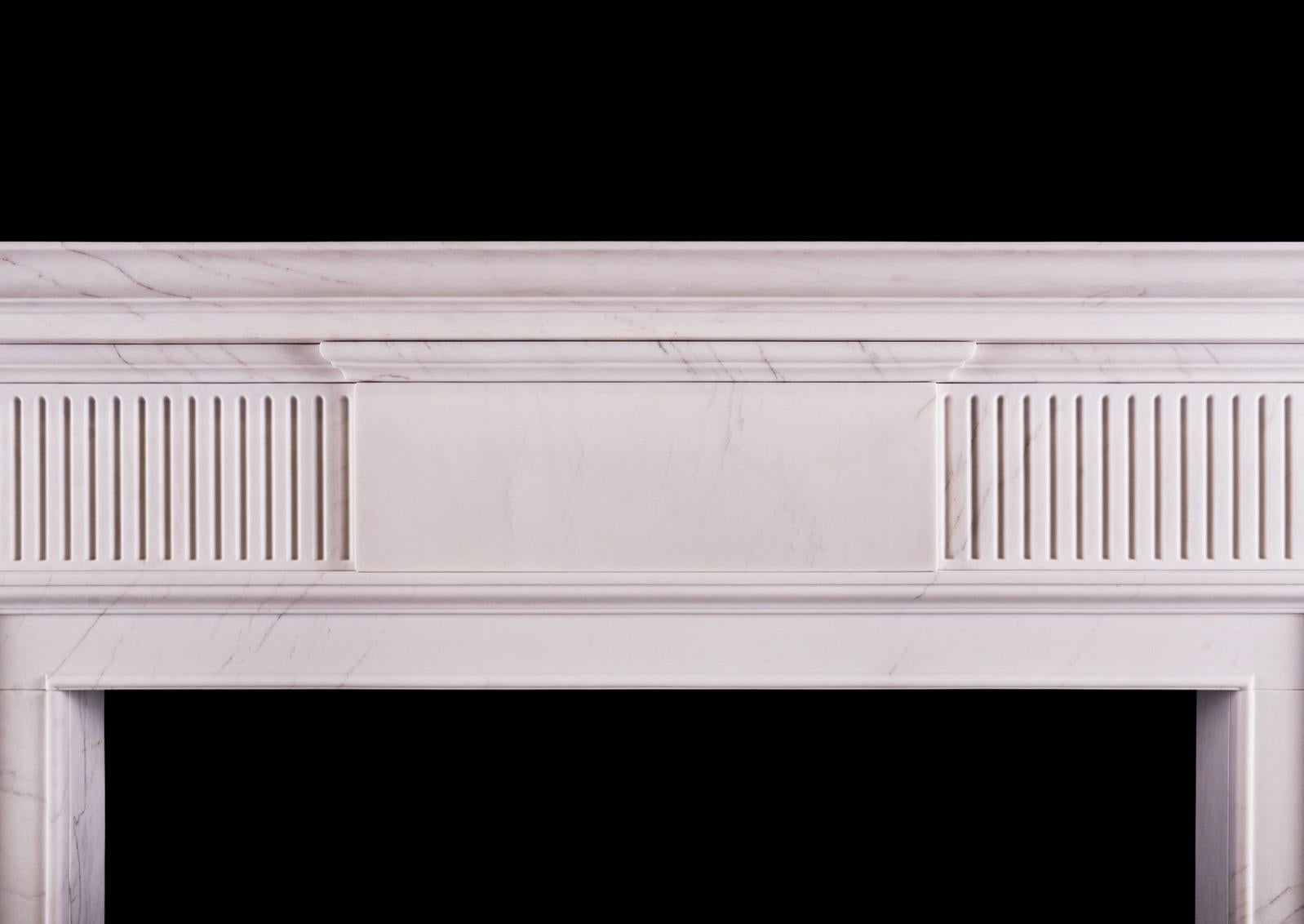 A simple neoclassical English fireplace in veined white marble. The moulded jambs surmounted by fluted frieze and plain centre blocking. Moulded shelf above.

Measurements: 
Shelf width: 1510 mm / 59 1/2 in
Overall height: 1290 mm / 50 3/4