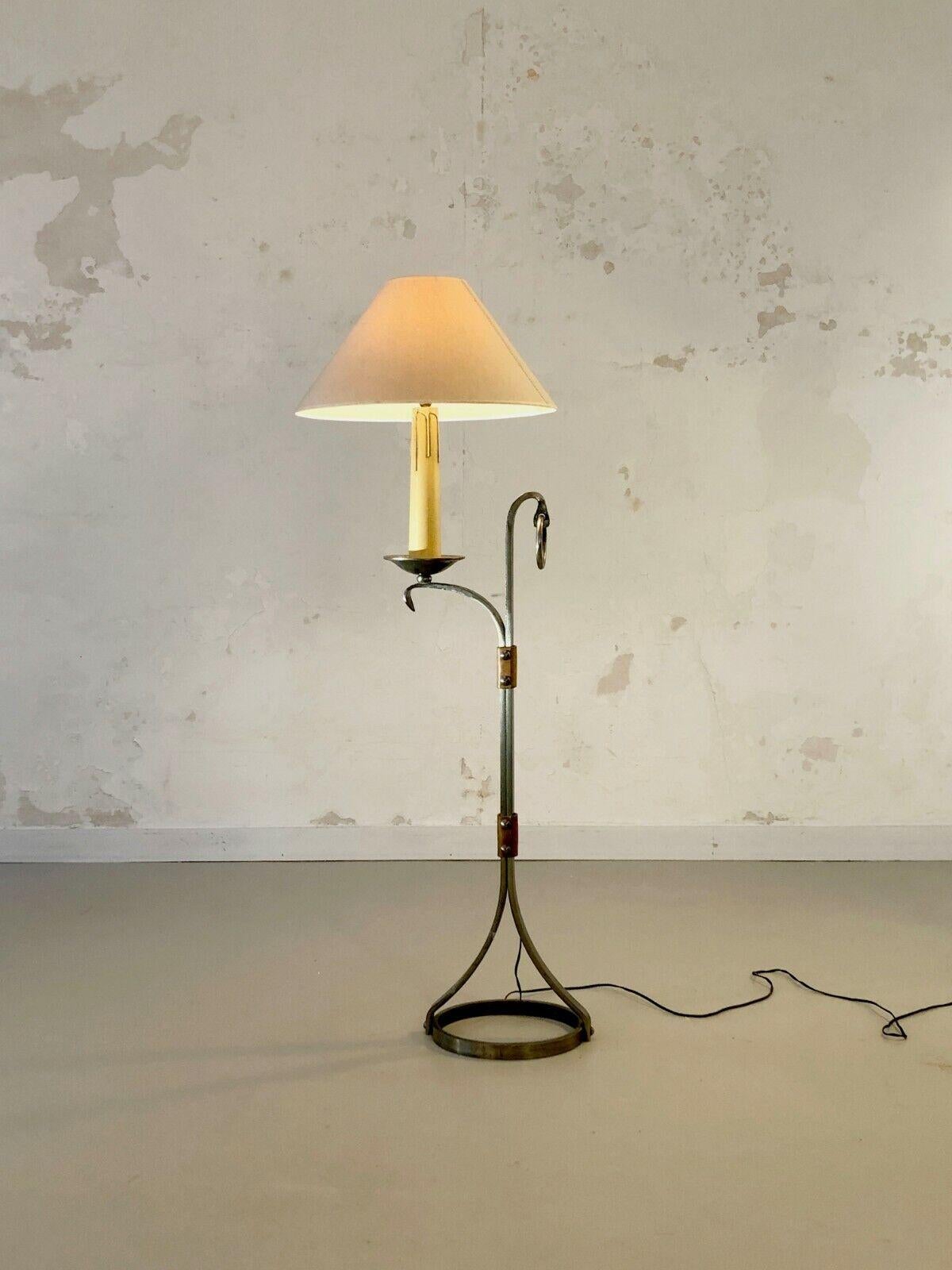 A small but massive floor lamp or reading light, Rustic-Modern, Art-Popular, Brutalist, Shabby-Chic, structure in solid hammered wrought iron and thick leather bolted to the structure, by Jean-Pierre Ryckaert, edition Ryckaert / Le Dauphin, France