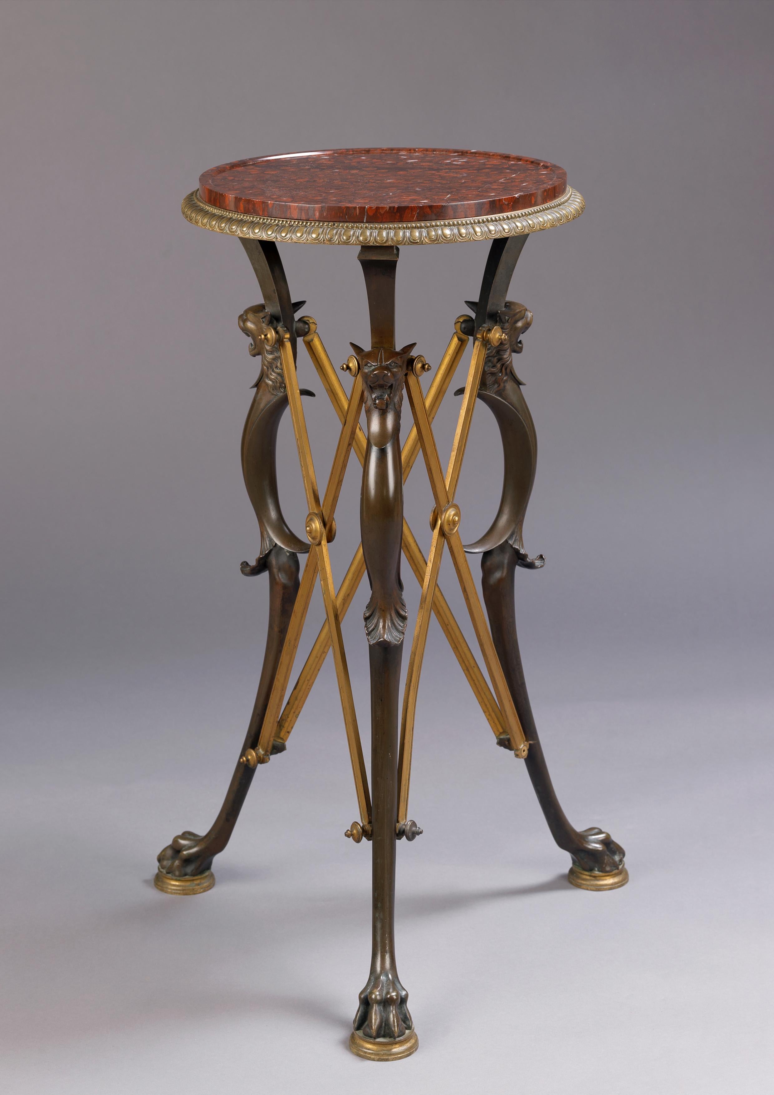 A fine neoclassical patinated and gilt bronze gueridon with a rouge griotte marble top, attributed to Barbedienne and Ferdinand Levillain. 

French, circa 1890. 

This striking gueridon has a circular inset rouge griotte marble top within a gilt
