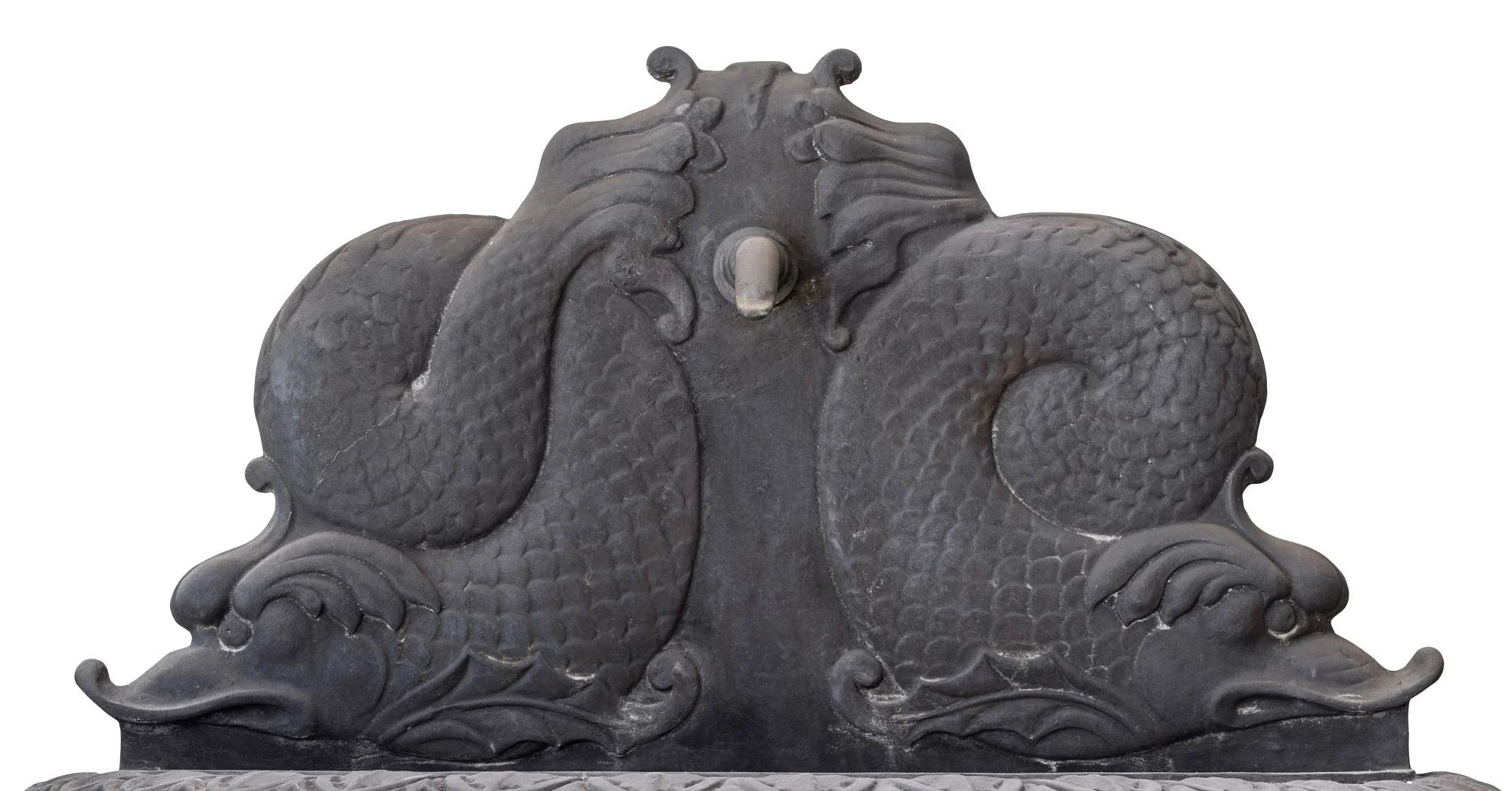 A Neoclassical Style Cast Bronze Dolphin Wall Fountain

Description:
Addorsed dolphins in relief with fountain head above a demi-lune basin.

Dimensions:
Height: 800cm.
Width: 1060cm.
Depth: 540cm.
Weight: Approximately 90kg.