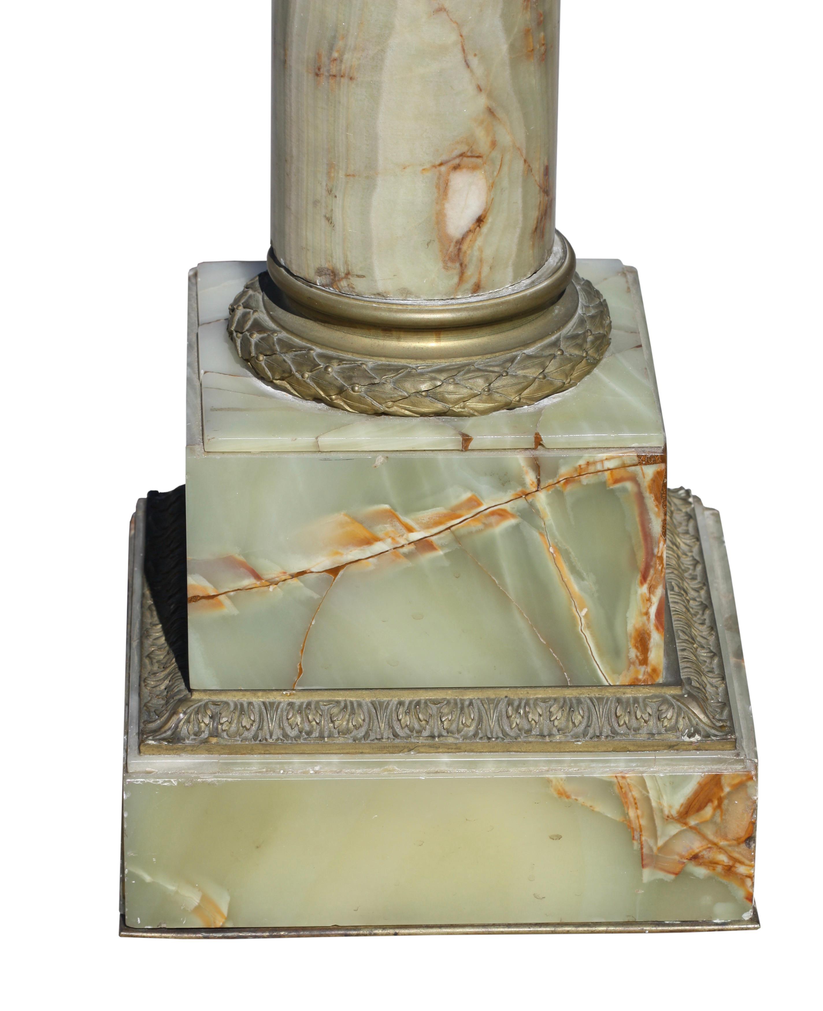 
A Neoclassical style gilt bronze mounted marble pedestal, Late 19th Century.
The variegated cream and ochre square top with molded edge on a foliate and rope cast gilt banded column on volute supports raised on octagonal base.
52