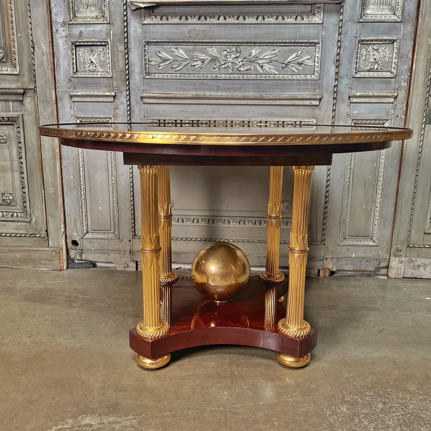 A neoclassical style center table designed and created for the late designer Alberto Pinto. This magnificent table has wonderful mahogany veneered top and beautiful gilt bronze mountings. It could be used as a small dining table as well. 
The