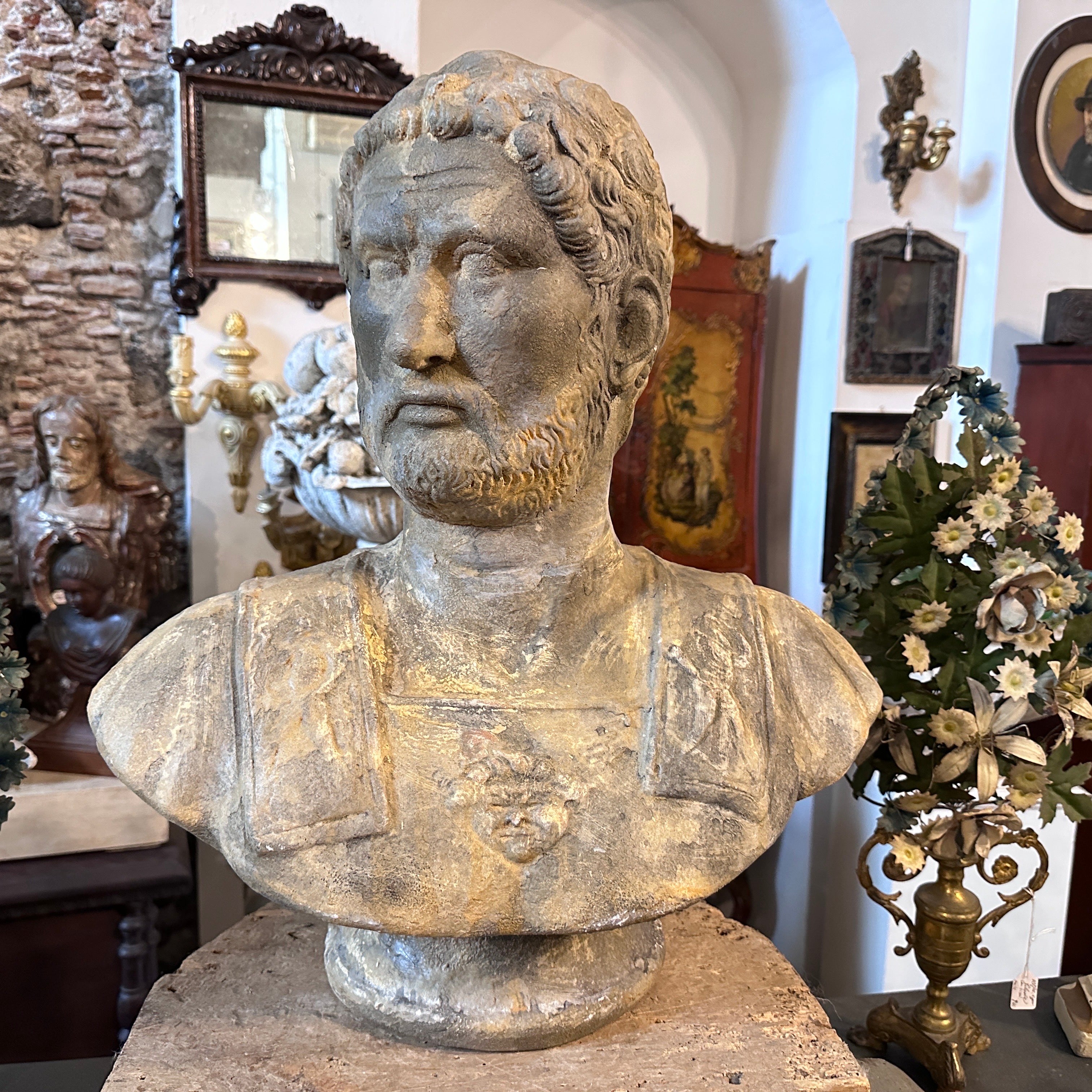 An original patina terracotta bust hand-crafted in Siclly in the first half of 20th century, it has signs of use and age. The bust of the Roman Emperor Adriano is a captivating and finely crafted sculpture that reflects the artistic influences of
