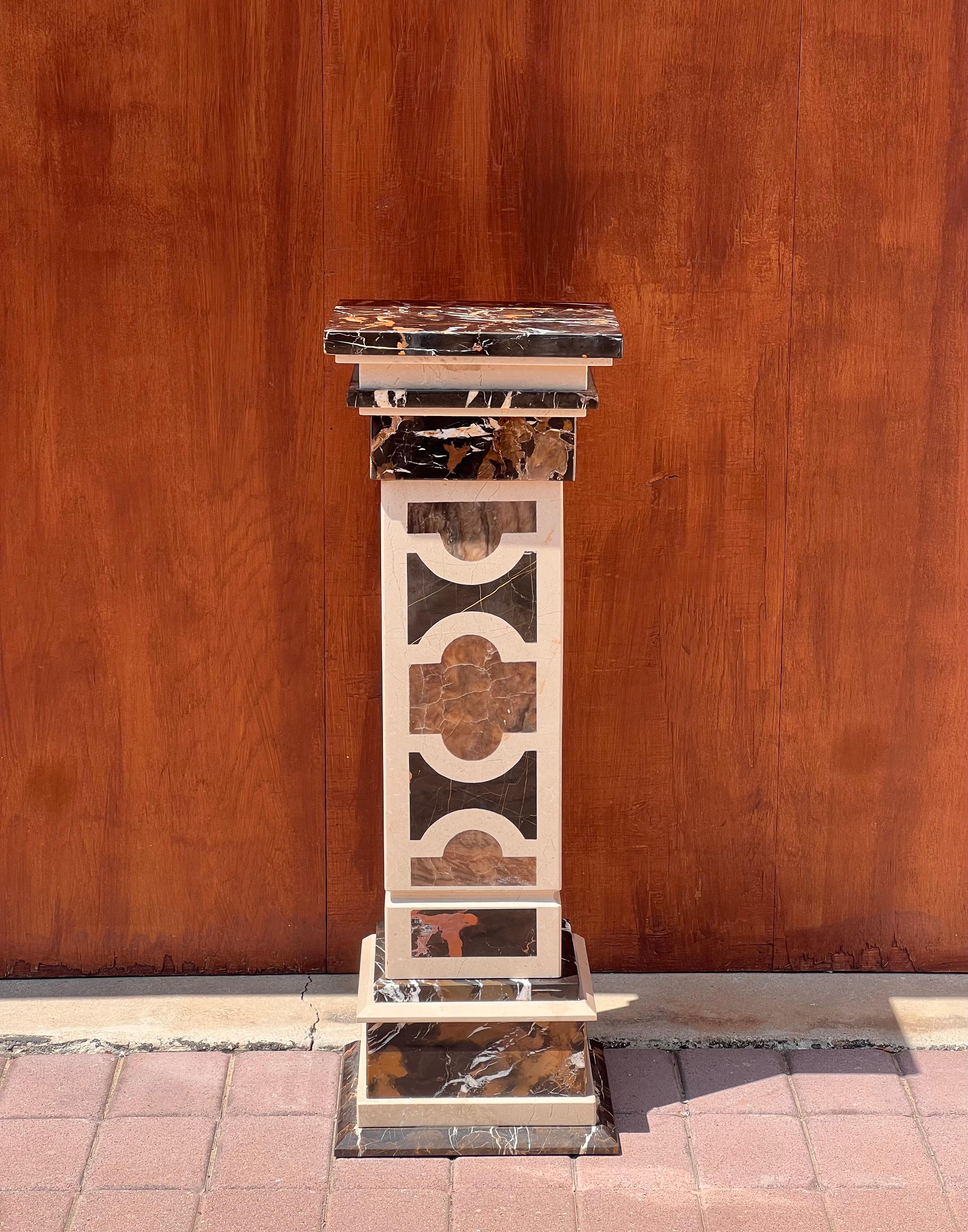 A handsome marble pedestal, Italy 20th century. In tones of chocolate, caramel, and heavy cream, and hand-crafted with a classical Italian motif using mixed marble that would be at home in any wing of the Getty Villa. This piece disassembles into
