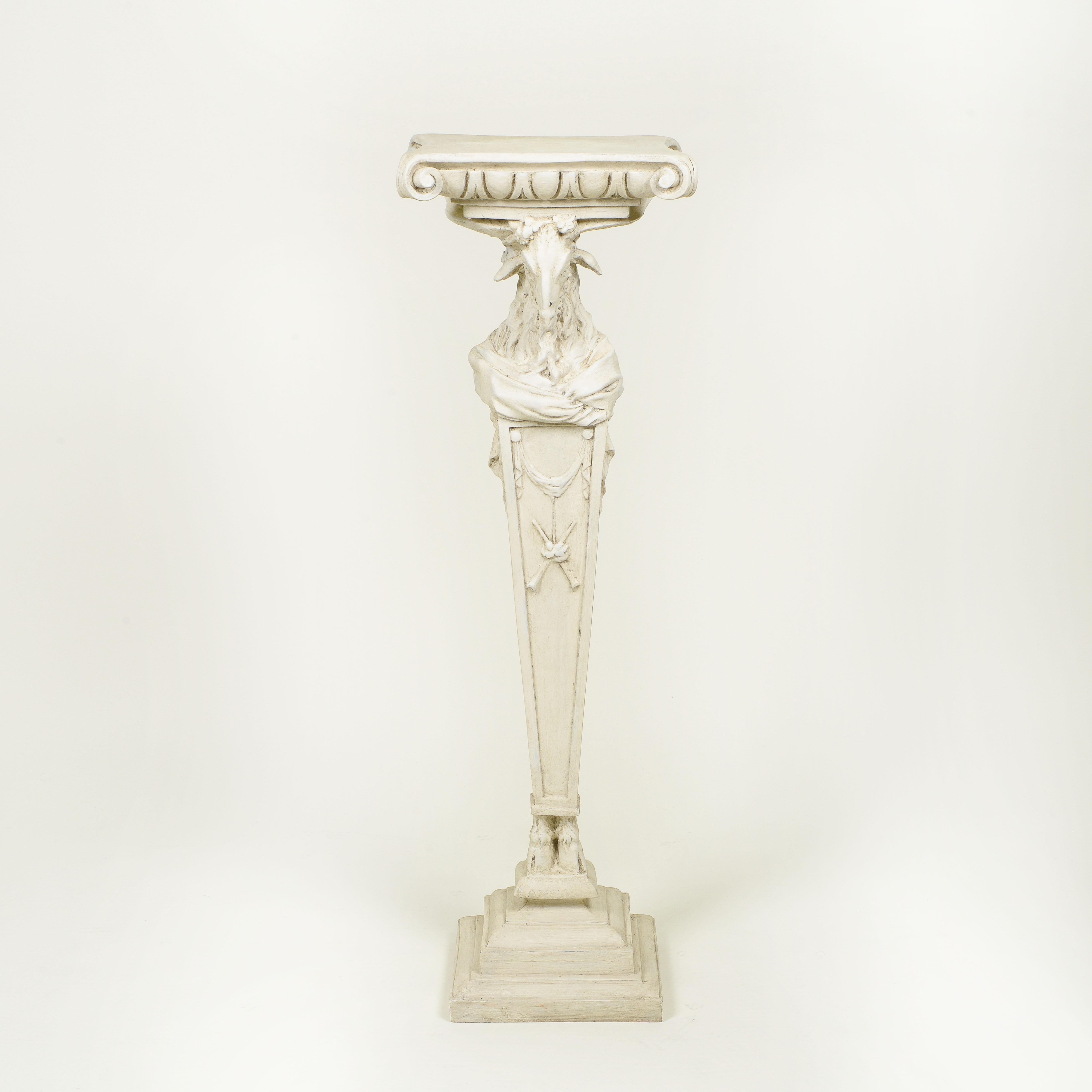 The square top carved in the form of an Ionic capital over ram's head supporting on a square tapering pedestal with drapery swag decoration.

Provenance: David Barrett