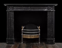 A 'Nero Marquina' marble fireplace of early 19th century design by RYAN & SMITH