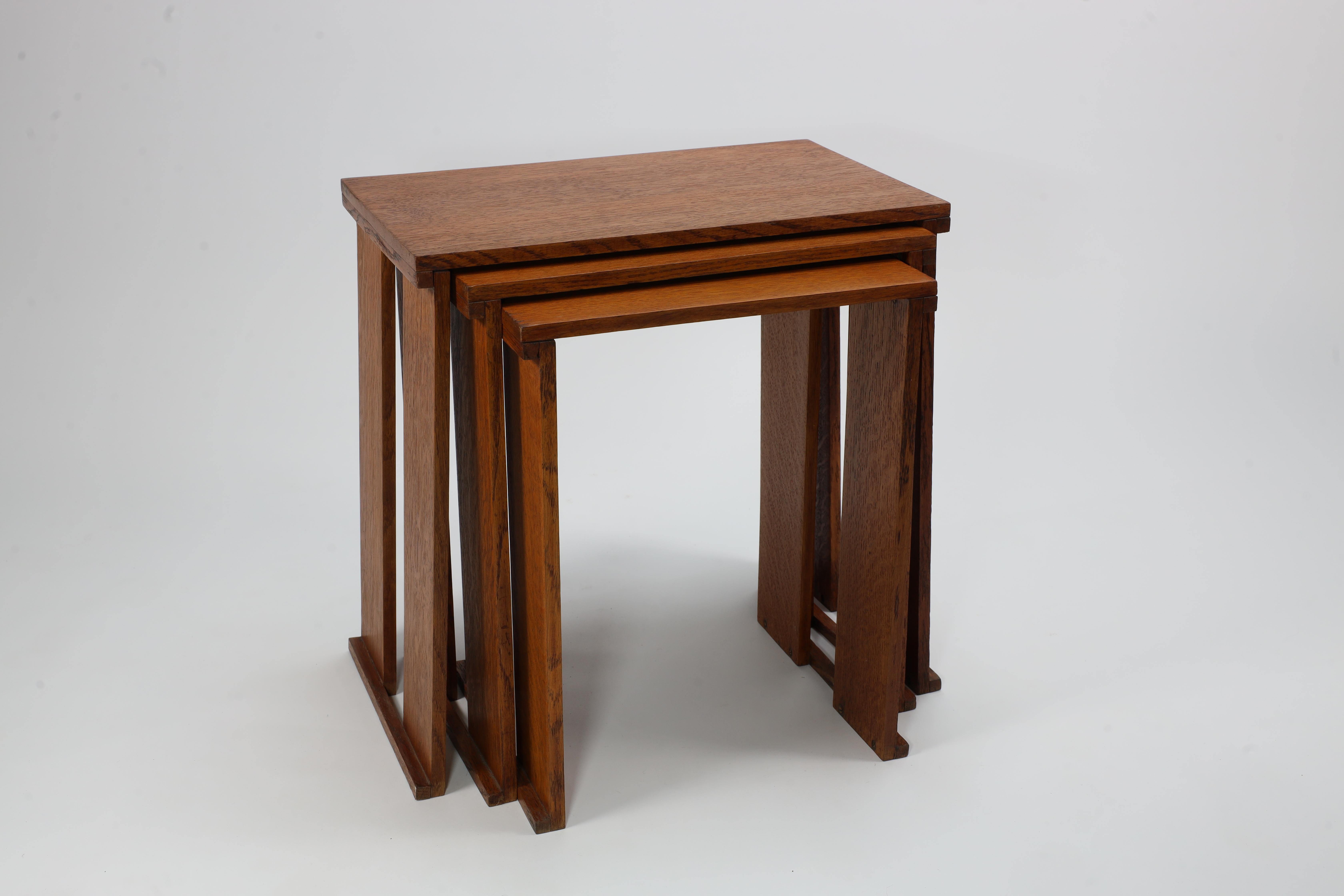 A nest of three Art Deco wild grain oak side tables of planked construction. 1