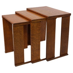 Antique A nest of three Art Deco wild grain oak side tables of planked construction.
