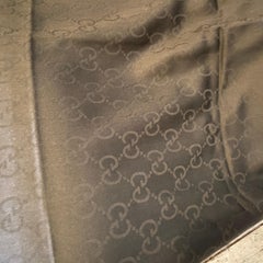 A Never Used Black Wool Scarf by Gucci with Continuous Logo