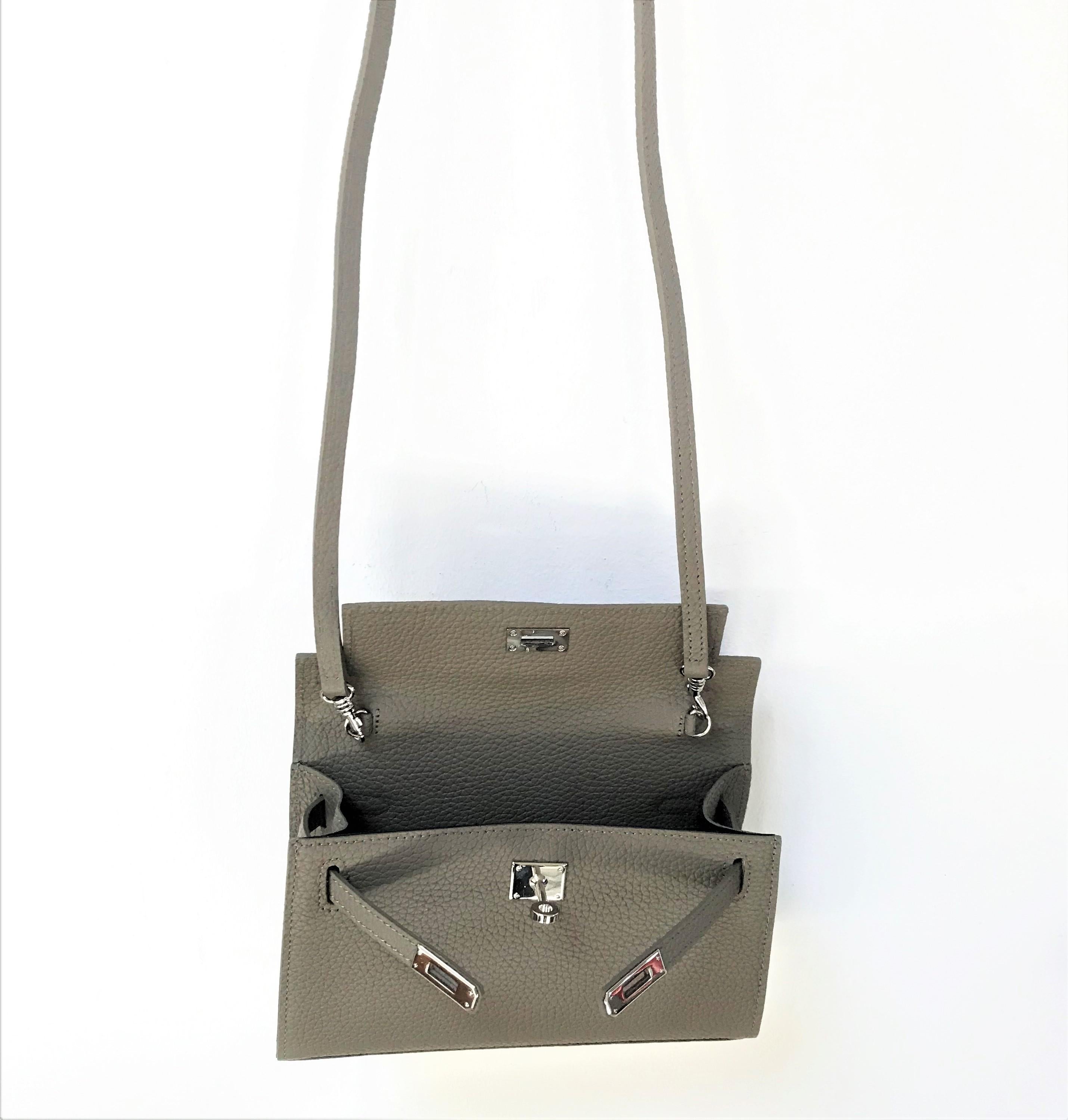 a new Pochette bag with detachable long shoulder strap made of  leather like chourcheval and silver hardware. The bag has an inside compartment and is lined with black fabric. Taub is a color how fit to all other colors.

Measurement: Width 22 cm,