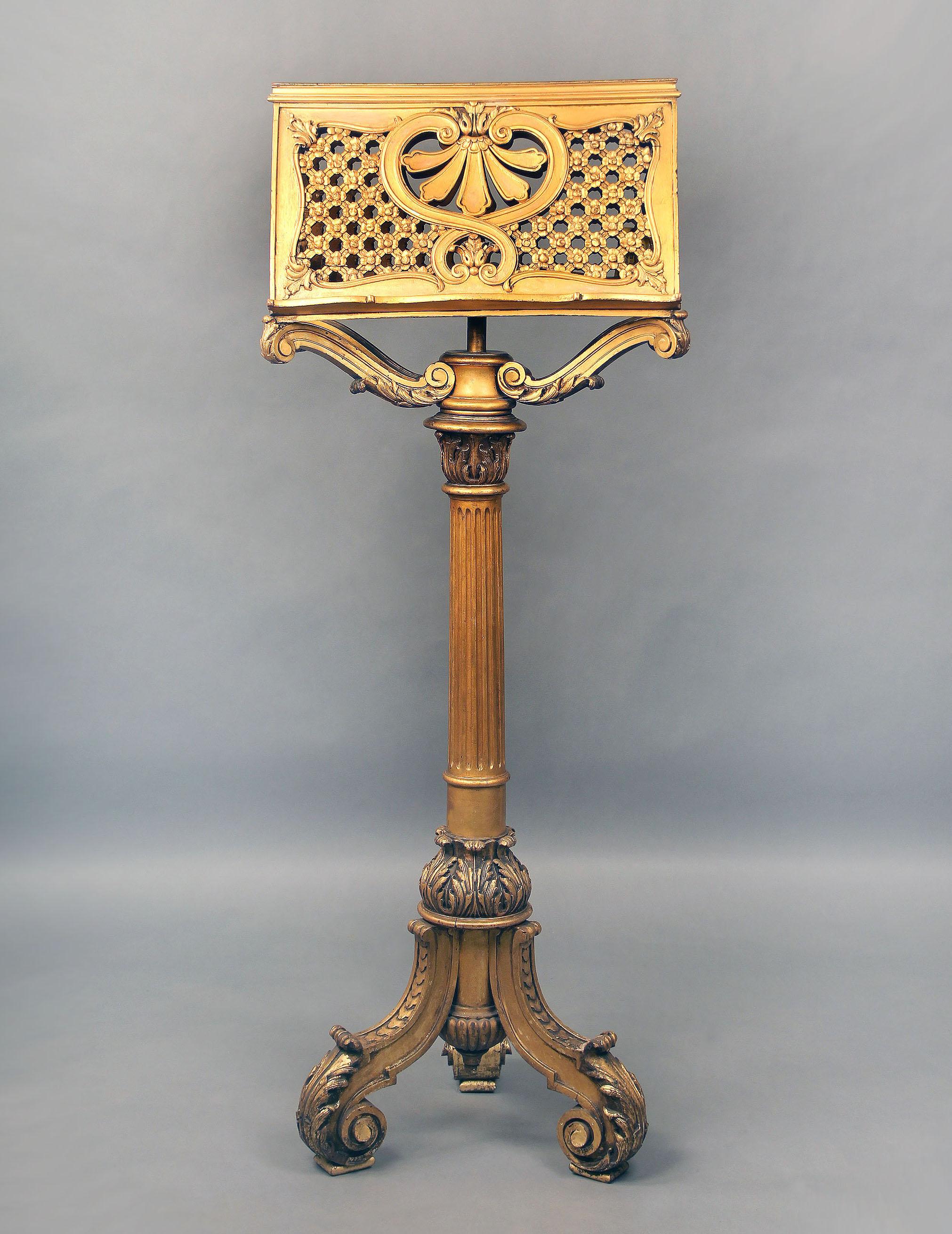 A Nice and Rare late 19th century Hand Carved Giltwood Music Stand.

The decorative double sided music rack with reticulated floral designs held up by four arms, the long body leading down to three intricately carved legs.
