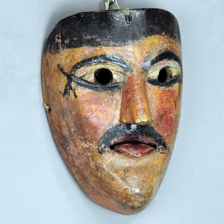 An antique wooden carved carnival mask from the region of South Tyrol. these masks are used in Austria, South Germany and Italy at the carnival “Fasnacht” processions to chase away winter. hand carved pine wood, hand painted, first of the half 20th