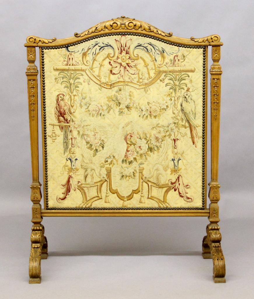 A nice early 20th century hand knitted tapestry screen.

The tapestry designed with parrots and swans with roses and flowers, enclosed in a hand carved wood frame.