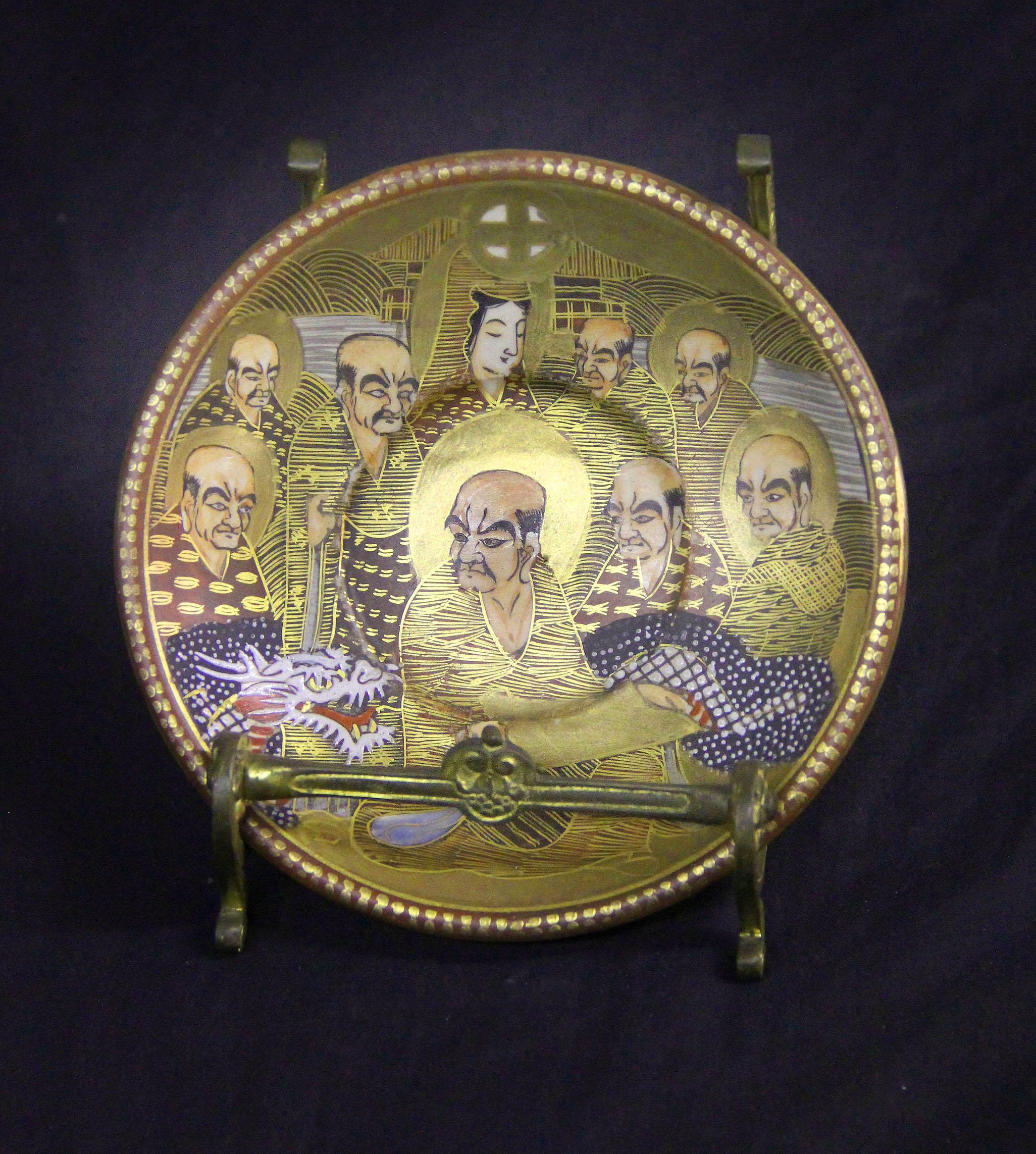A Nice Early 20th Century Japanese Imperial Satsuma Porcelain Plate

Beautifully painted with men, women and a dragon, sitting in a bronze frame.

Details:
Height on stand – 4 inches / 10cm
Diameter of Plate – 4.75 inches /12cm