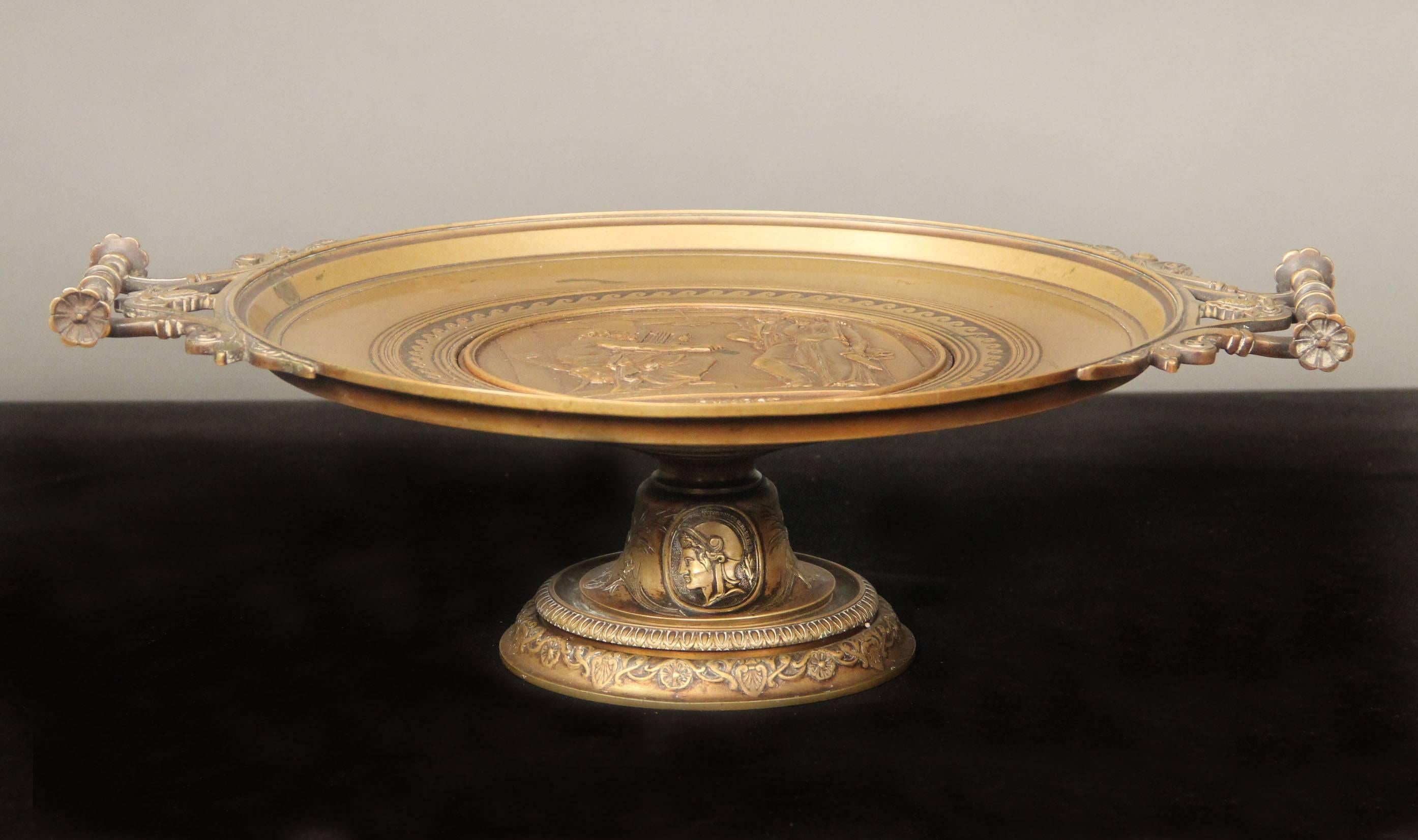 A nice late 19th century gilt bronze centrepiece

Signed E. Picault

A large bronze plate centered with a classical scene raised on a base.

Émile Louis Picault (24 August 1833-1915) was a French sculptor, best known for works depicting