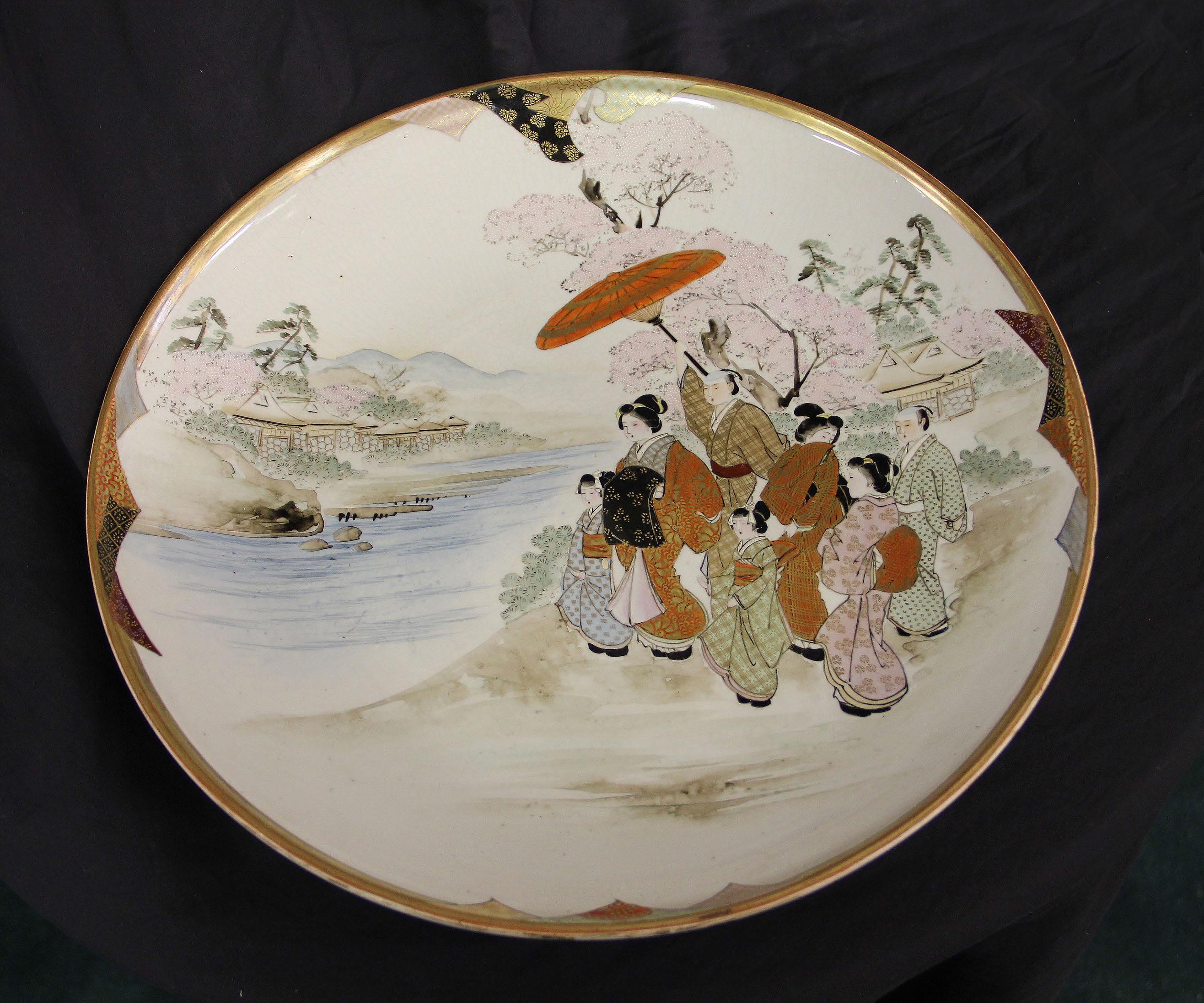 A nice pair of early 20th century Japanese Kutani plates

These highly decorated plates depict a family standing by a river and a village, with raised gilt and painted designs.

Kutani ware (??? Kutani-yaki) is a style of Japanese porcelain