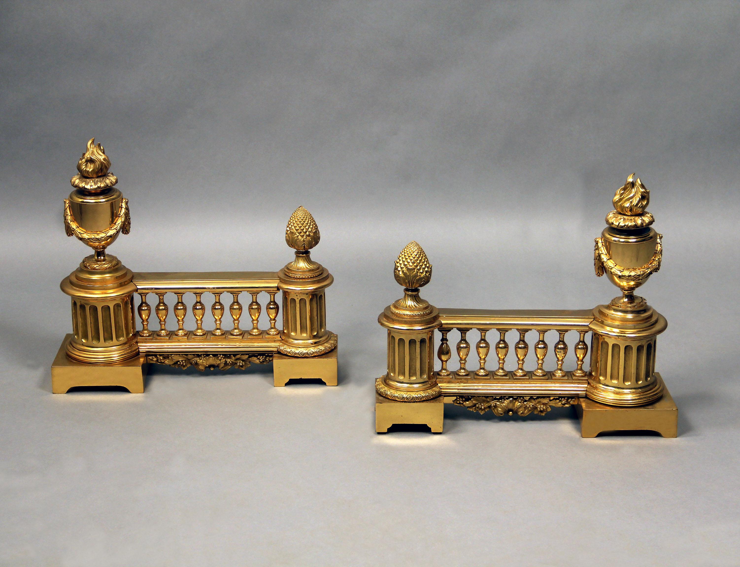 A Nice Pair of Late 19th Century Gilt Bronze Chenets

Each with swagged flaming-urn finial, flanked by pine cone finial.