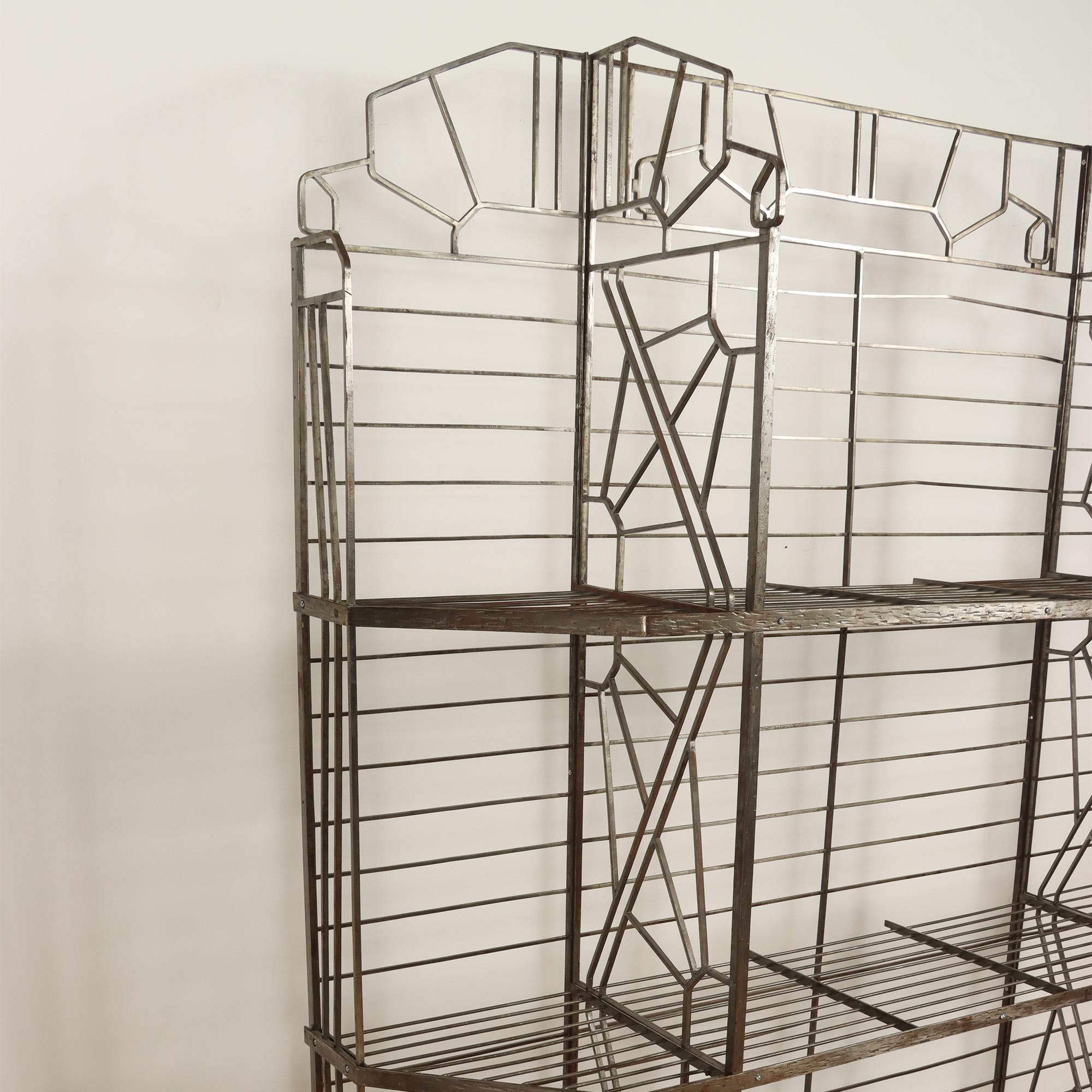 A French nickel over iron Art Deco bakers rack with glass shelves, C 1930.
   